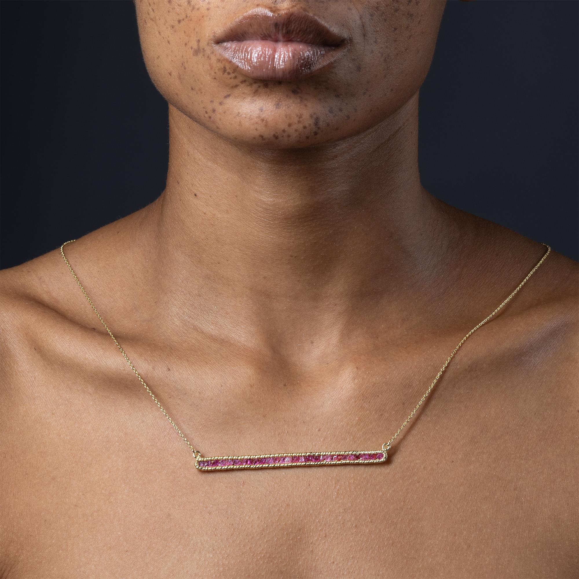 The Lithos Necklace from the GKey Collection features a line of natural raw rubies set in 925 sterling silver plated with 14K gold. Each ruby is left completely unpolished, showcasing its natural surface and true character as it was mined. The piece