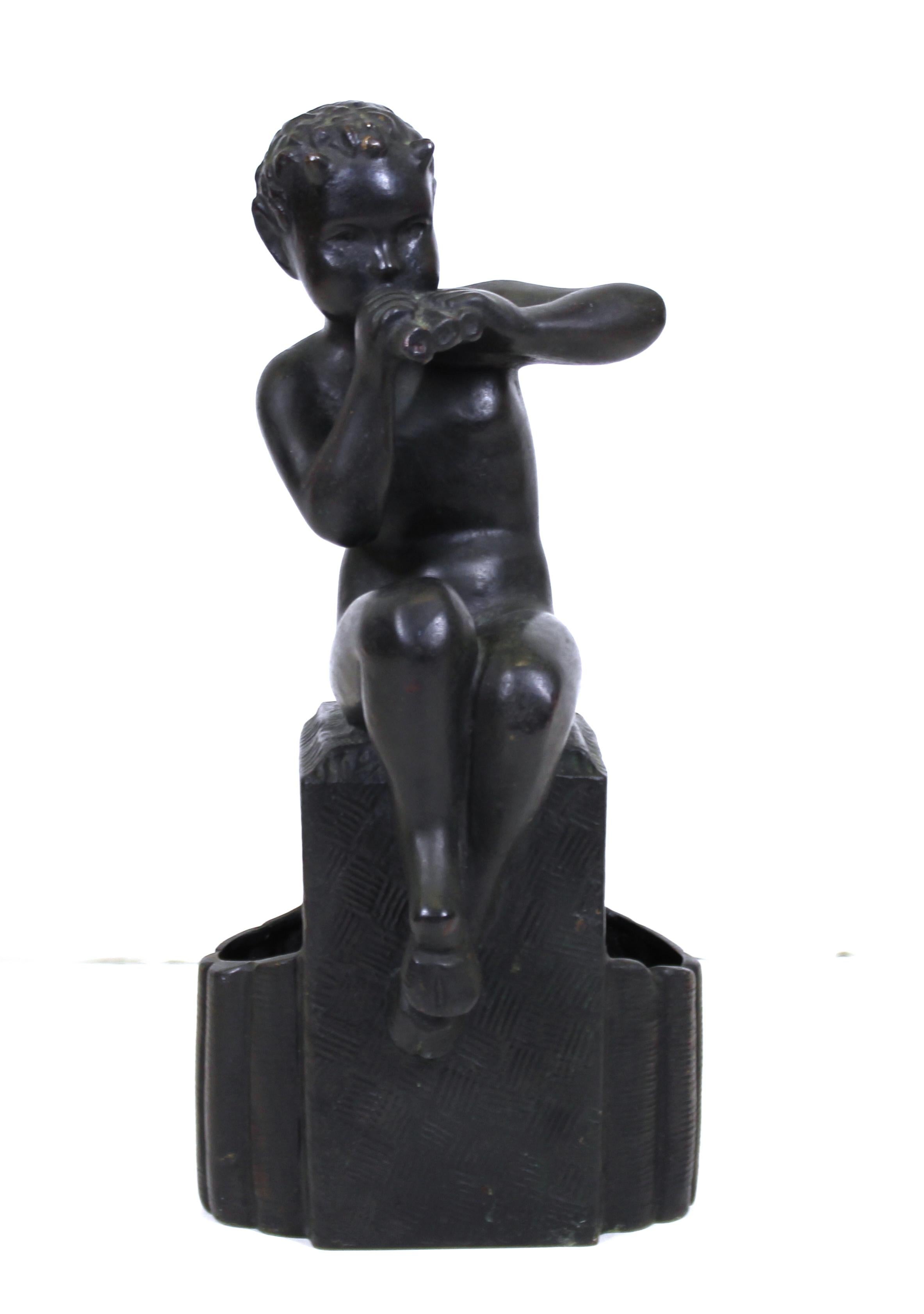 German early Art Deco bronze sculpture of a young seated pan playing his flute. The piece is stamped with a signature 'Kleiner' on the back of the base and has an overall dark patina. Made in Germany during the 1920s, it is in great antique