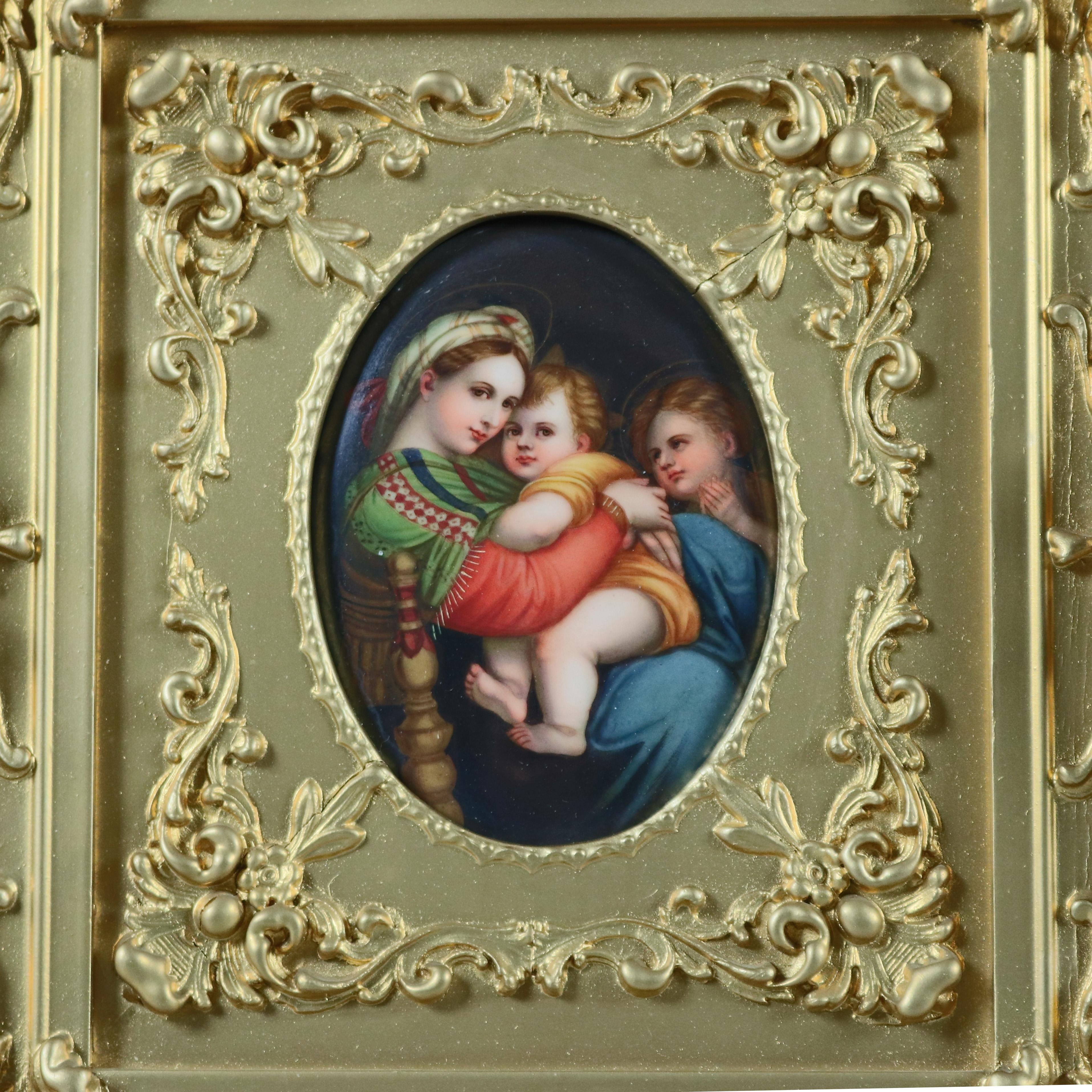 An antique German KPM School hand painted polychrome old master porcelain plaque of Madonna Della Sedia after Raphael depicts The Madonna Mother Mary and Christ Child attended by Saint John, seated in foliate decorated giltwood frame,