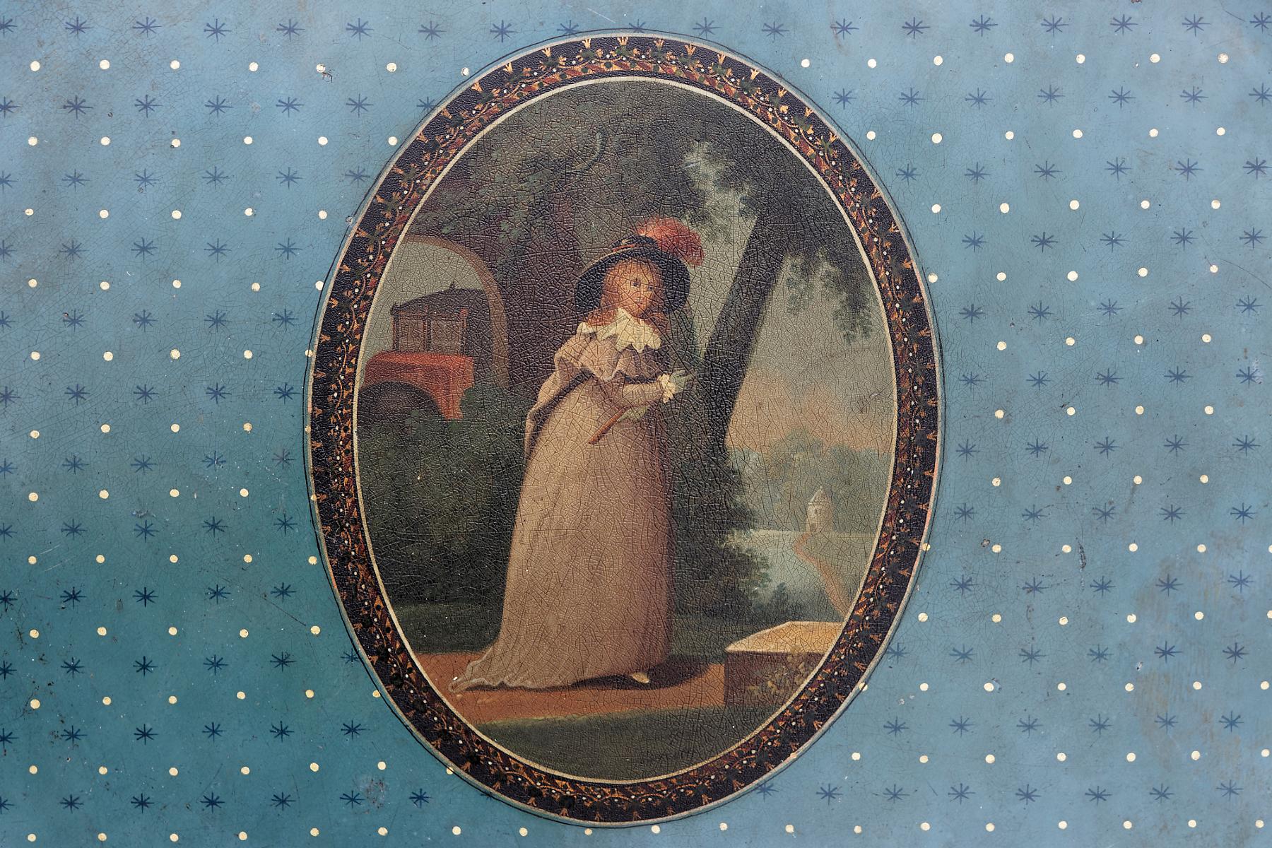 A finely painted German polychrome oval metal tray. Decorated overall with alternating stars and golden dots against a blue background, in the centre an upright oval with an elegantly dressed young girl wearing gloves and a hat within a classical