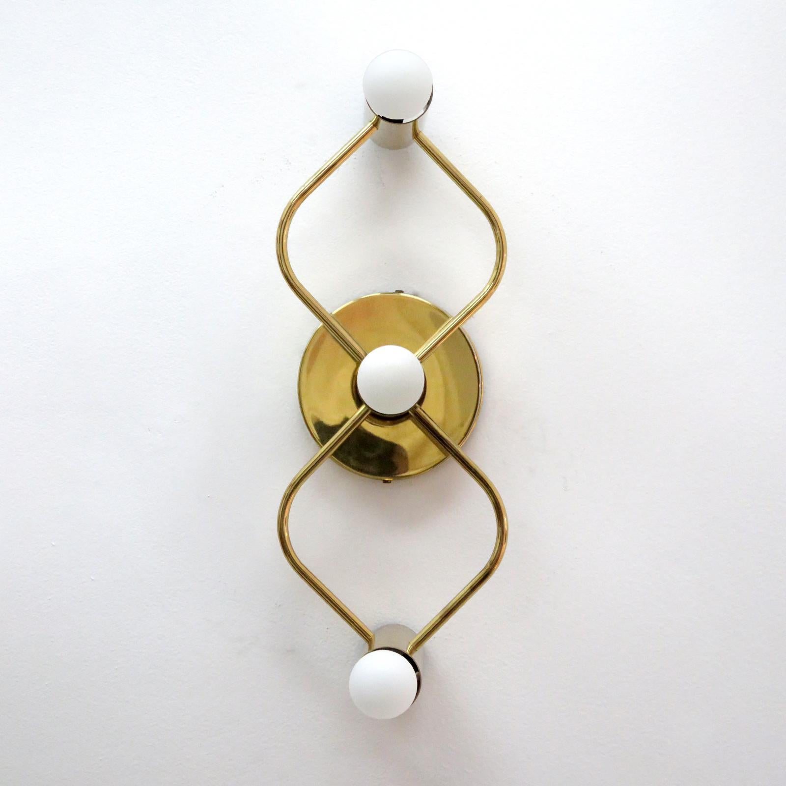 Wonderful three-light flush mount light fixture in polished brass, can be used horizontally or vertically, as wall or ceiling light, wired for US standards, three E12 sockets, max. wattage 60w per socket, bulbs provided as a one time courtesy.