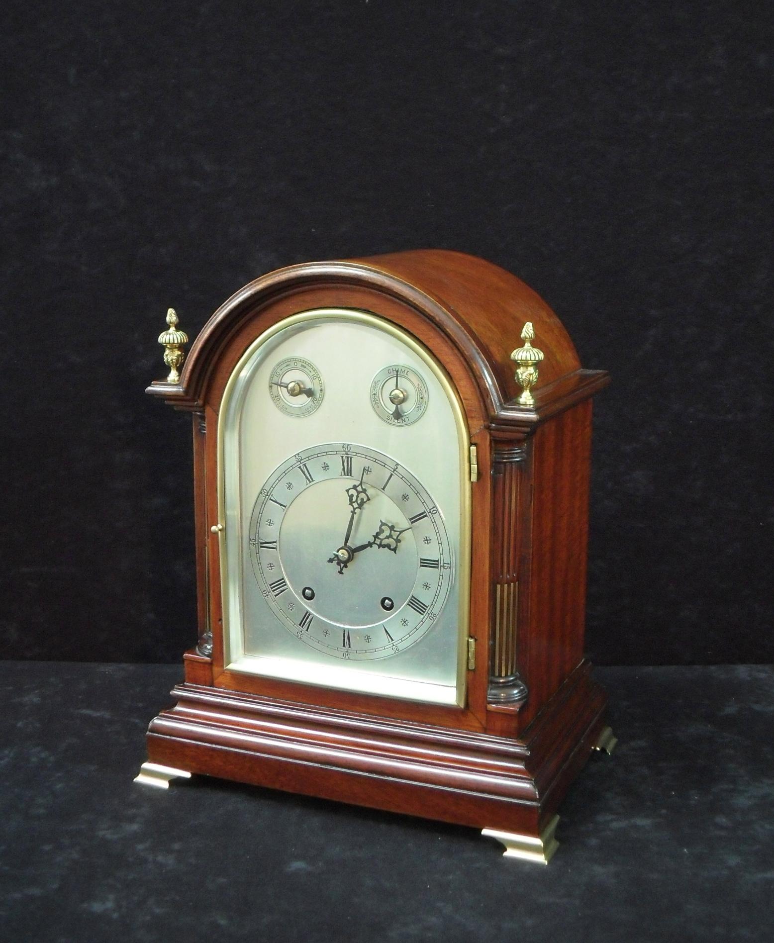 A very good quality late Victorian mahogany arched top bracket or table clock with quarter columns and brass string inlay. The clock has a silvered dial with slow-fast and silent-strike mechanism. The clock has a German Winterhalder & Hofmeier ting