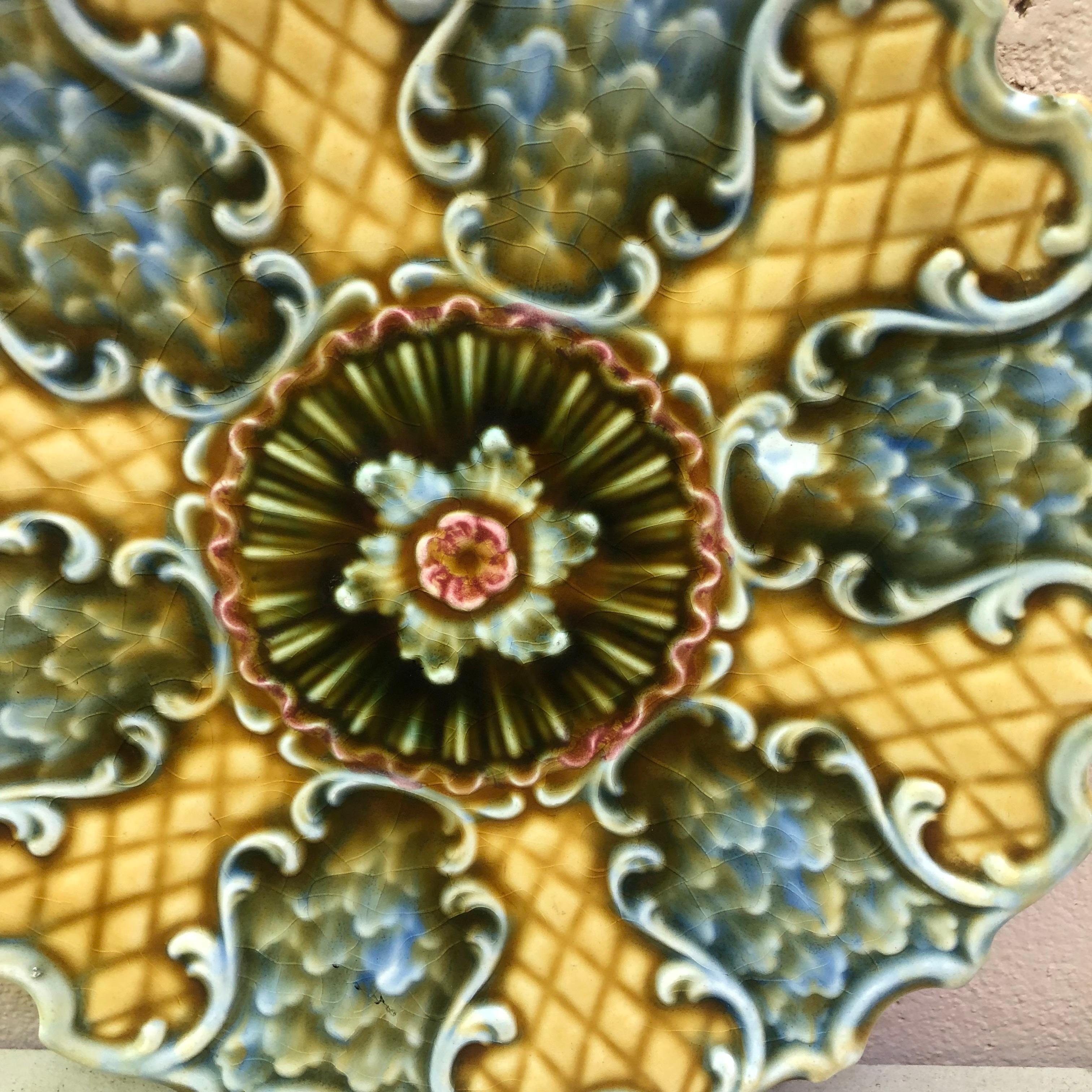 Majolica German plate circa 1900 with geometrical pattern and flower on the center.