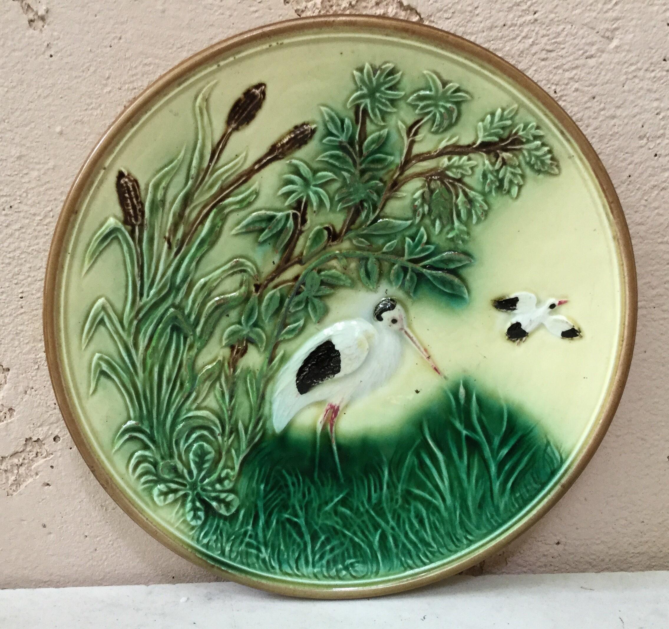 German Majolica stork plate with reeds and trees. circa 1900.