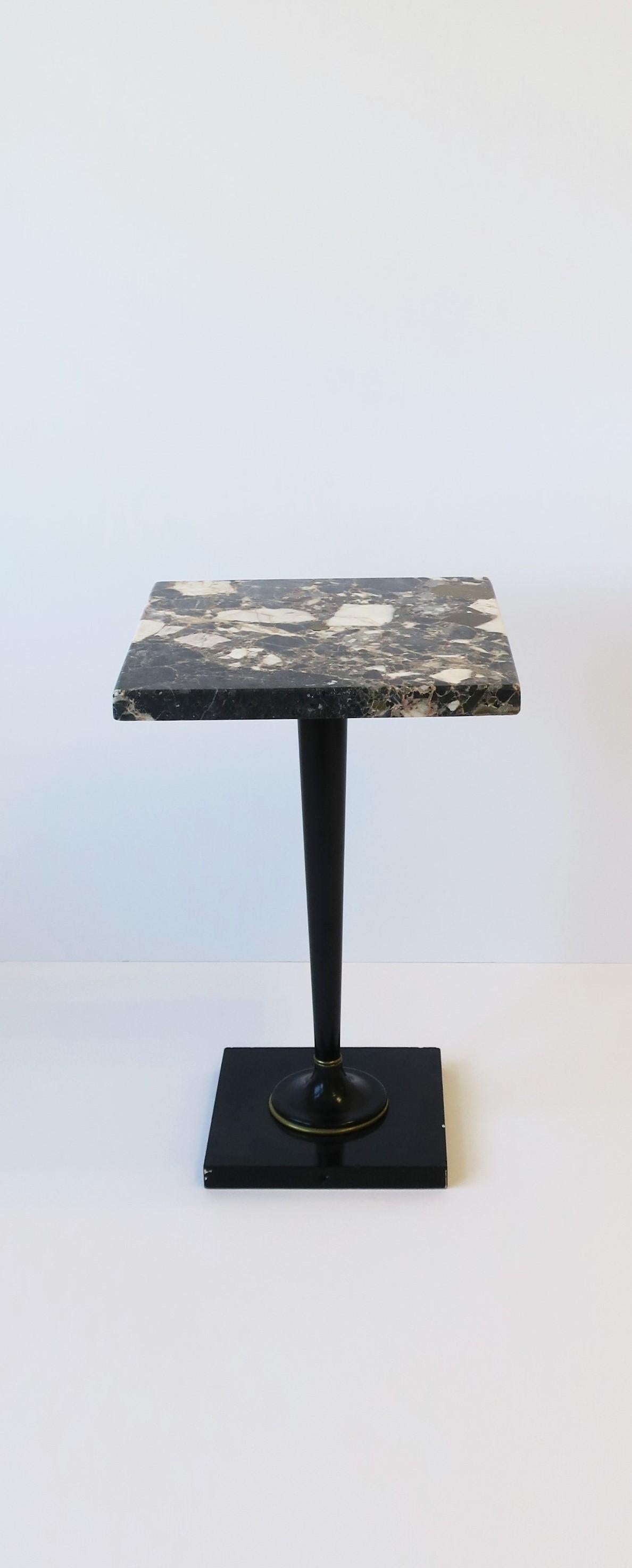A small multicolored marble and black lacquered side or drinks table from Germany, circa mid-20th century. Square top is marble; prominent hues include dark blue, blue-grey, dark taupe, and white. Base is marble finished with black lacquer, center