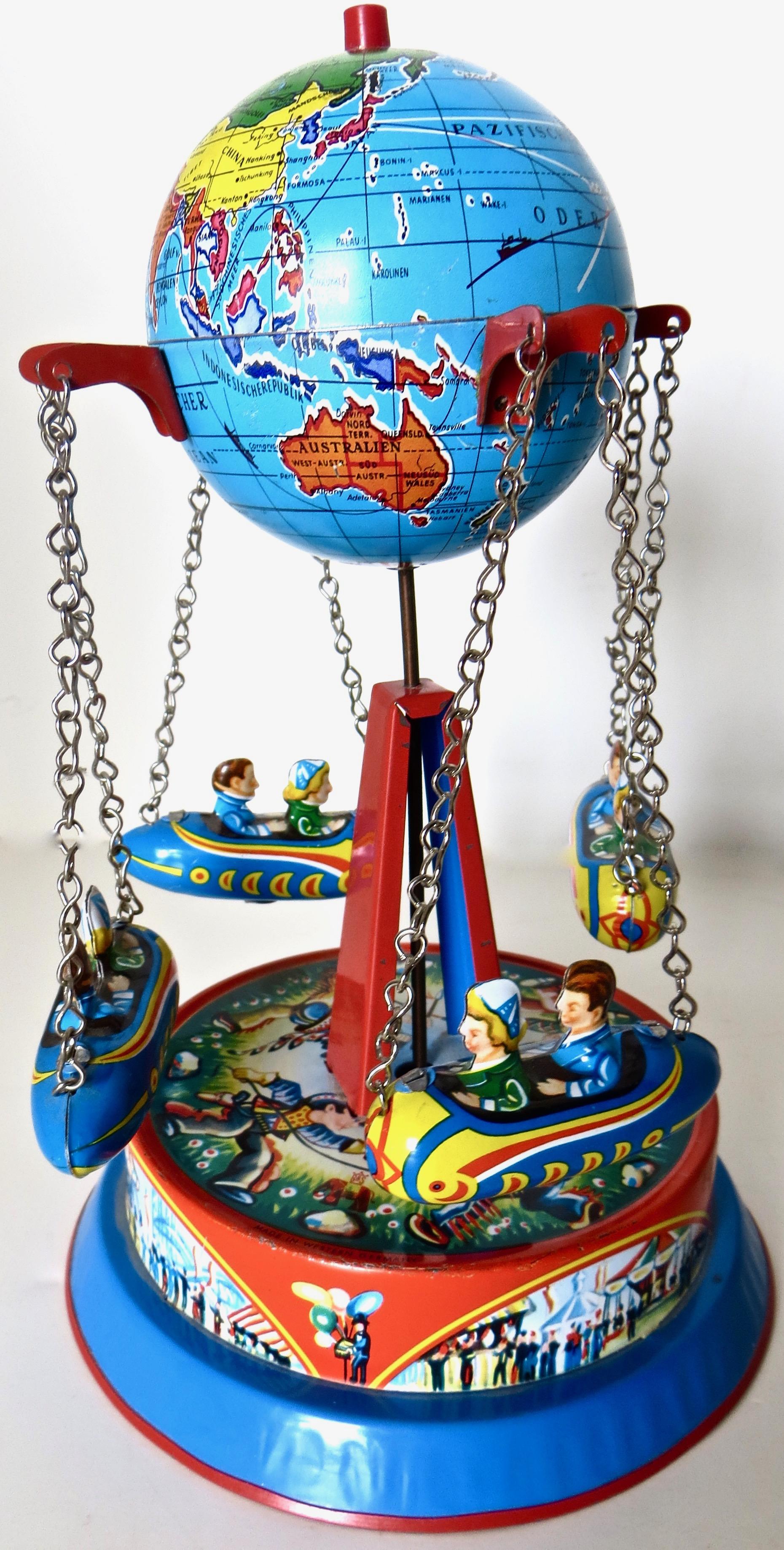 Spring loaded carousel rocket ride toy with a world globe 