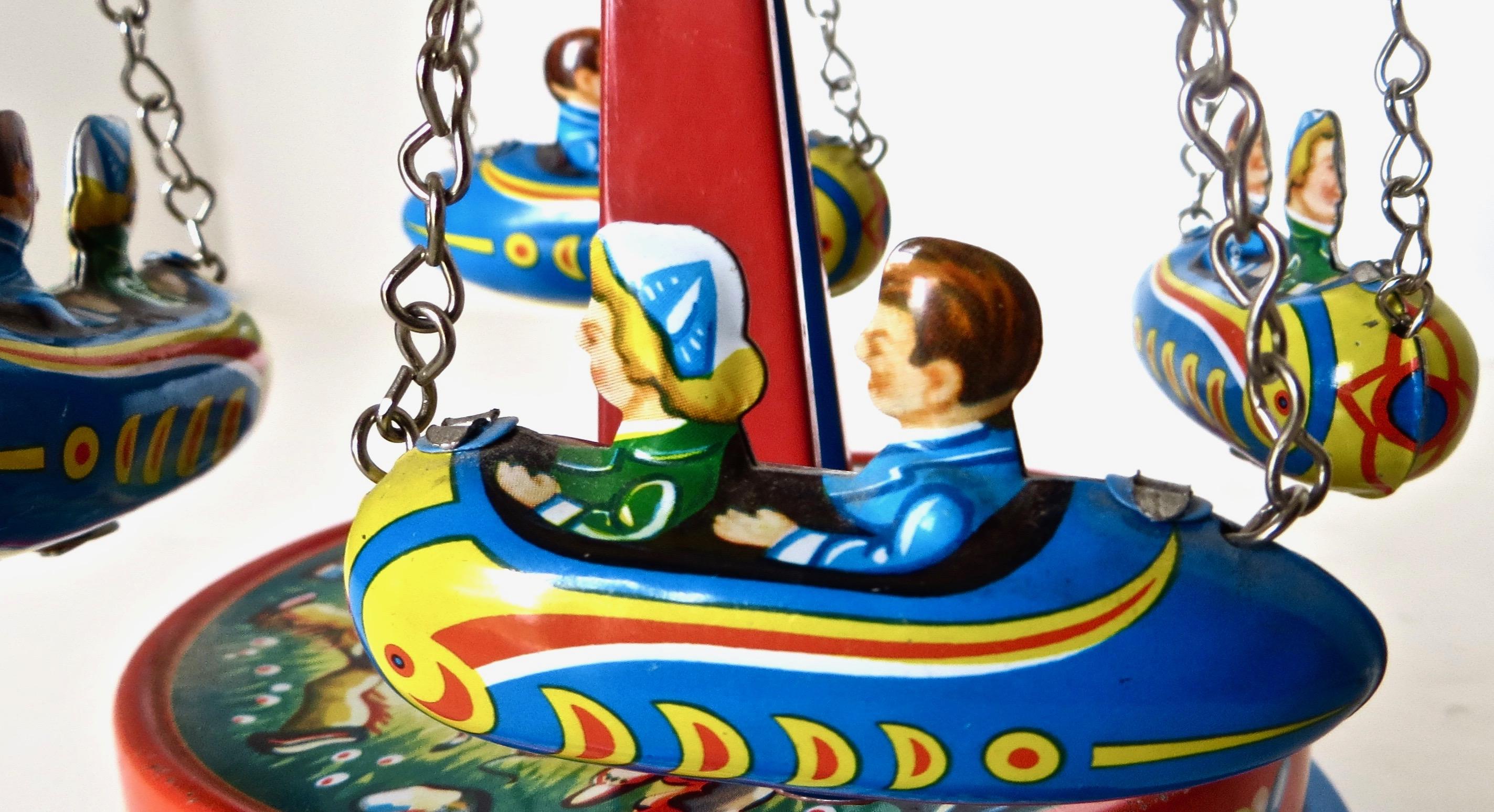 German Mechanical Carousel Rocket Lithographed Tin Toy, Circa 1950's In Good Condition In Incline Village, NV
