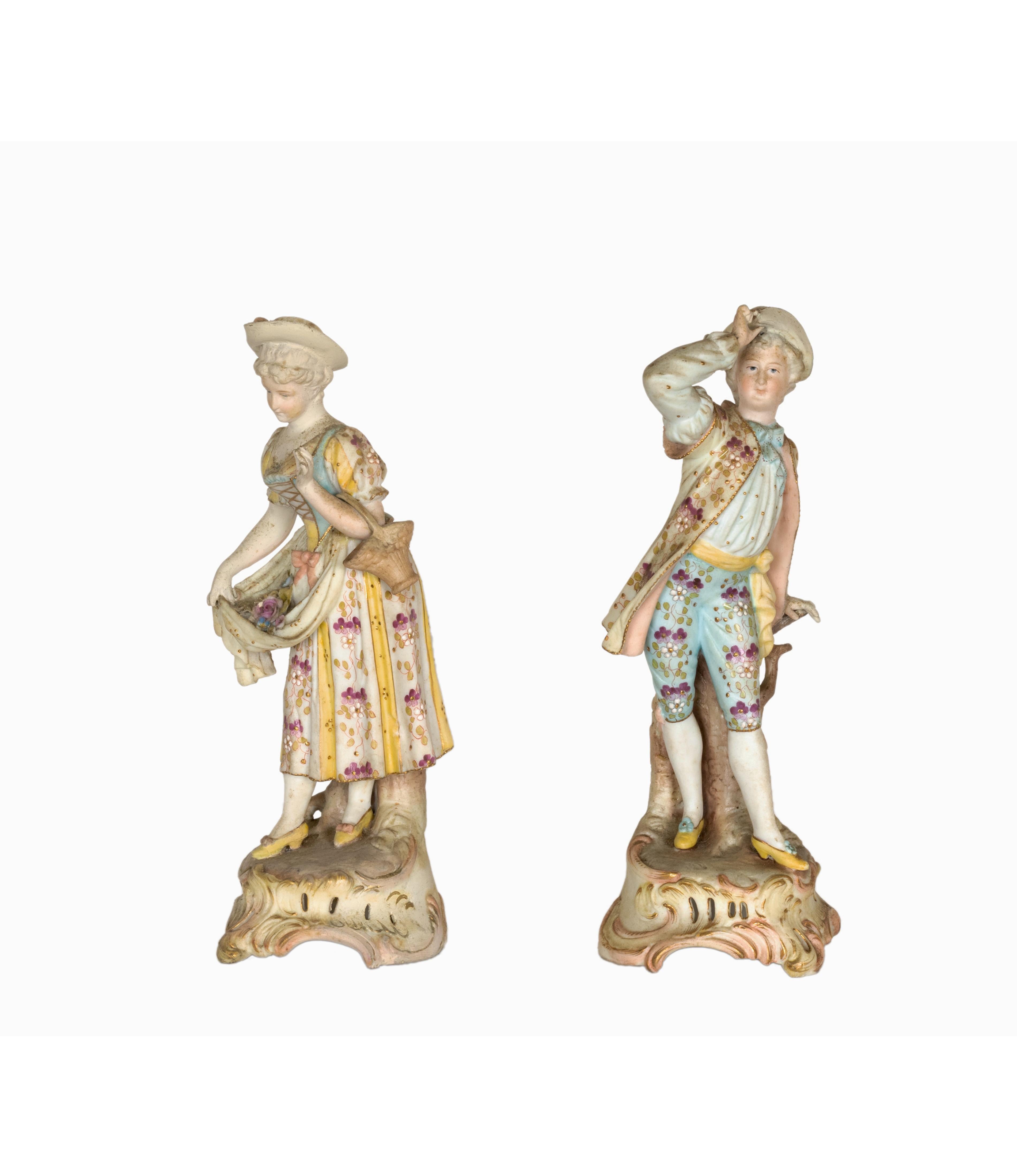 A pair of Meissen polychrome porcelain figurine in Baroque style costumes with flowers and a Meissen Deer Head mark. 
Broken finger in the girl`s hand.

Madam Height: 19.5 cm Diameter 7.5 cms
Gentleman Height: 20 cm Diameter 7.5 cm

