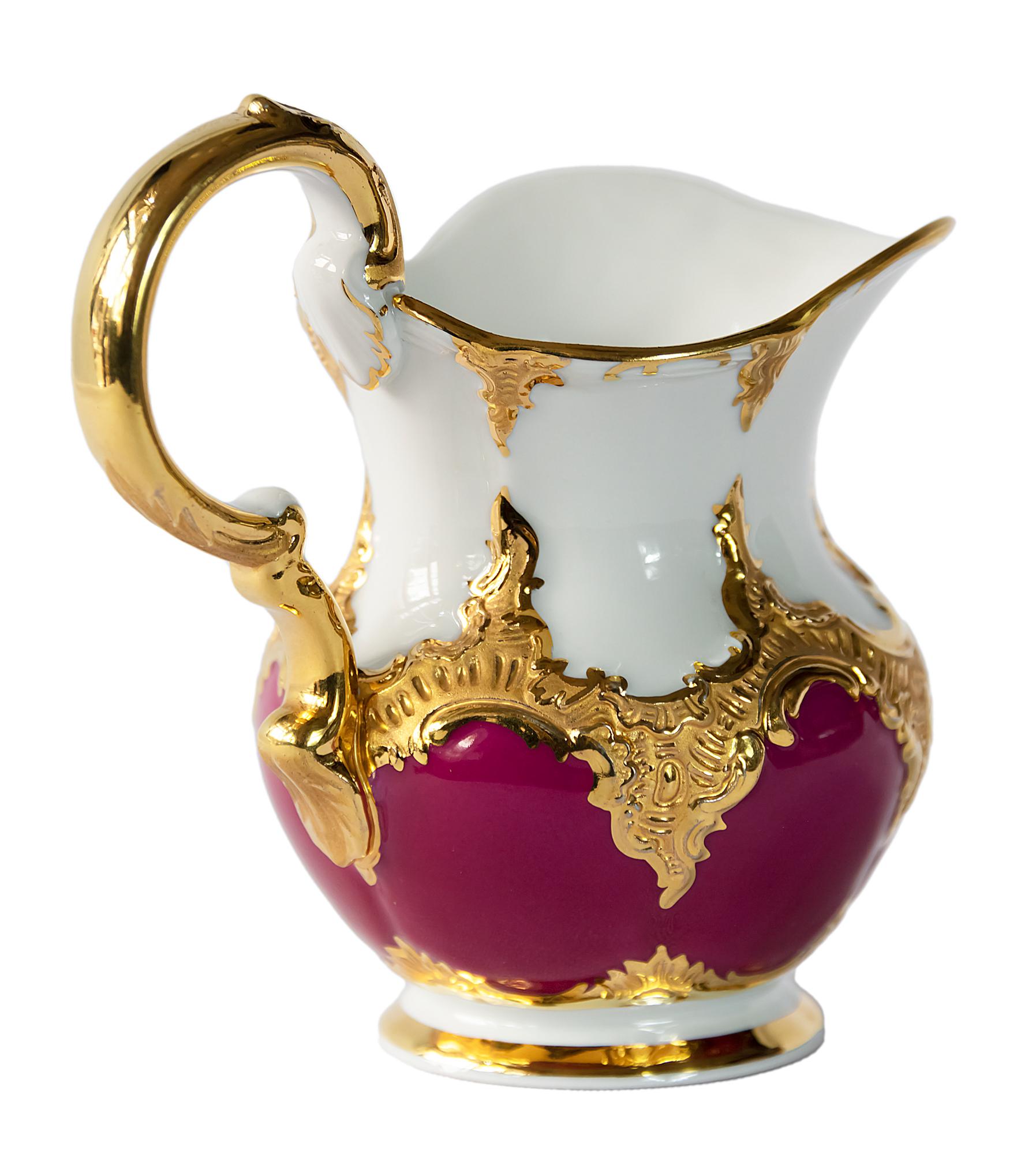 German Meissen porcelain milk pitcher / jug.
Porcelain is hand painted partly in red colour with rich gold decor.
The logo marked on the bottom.