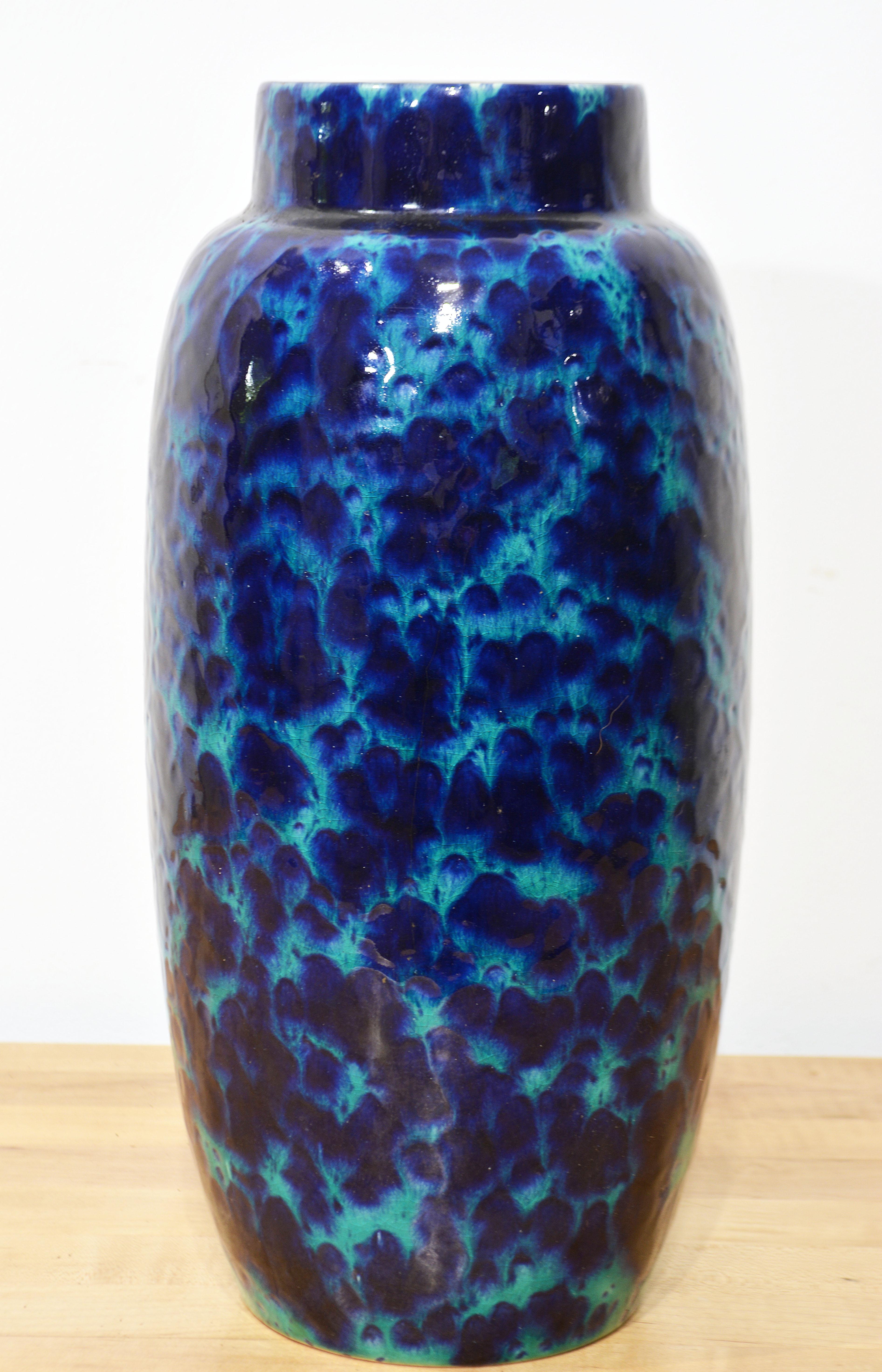 Of elegant form and with an interchanging deep blue and Turquoise fat lava style glaze this vase adds timeless vibrancy and style to a home.. The vase is inscribed West Germany and the number 553-38 on the bottom and is made by Scheurich Keramik in