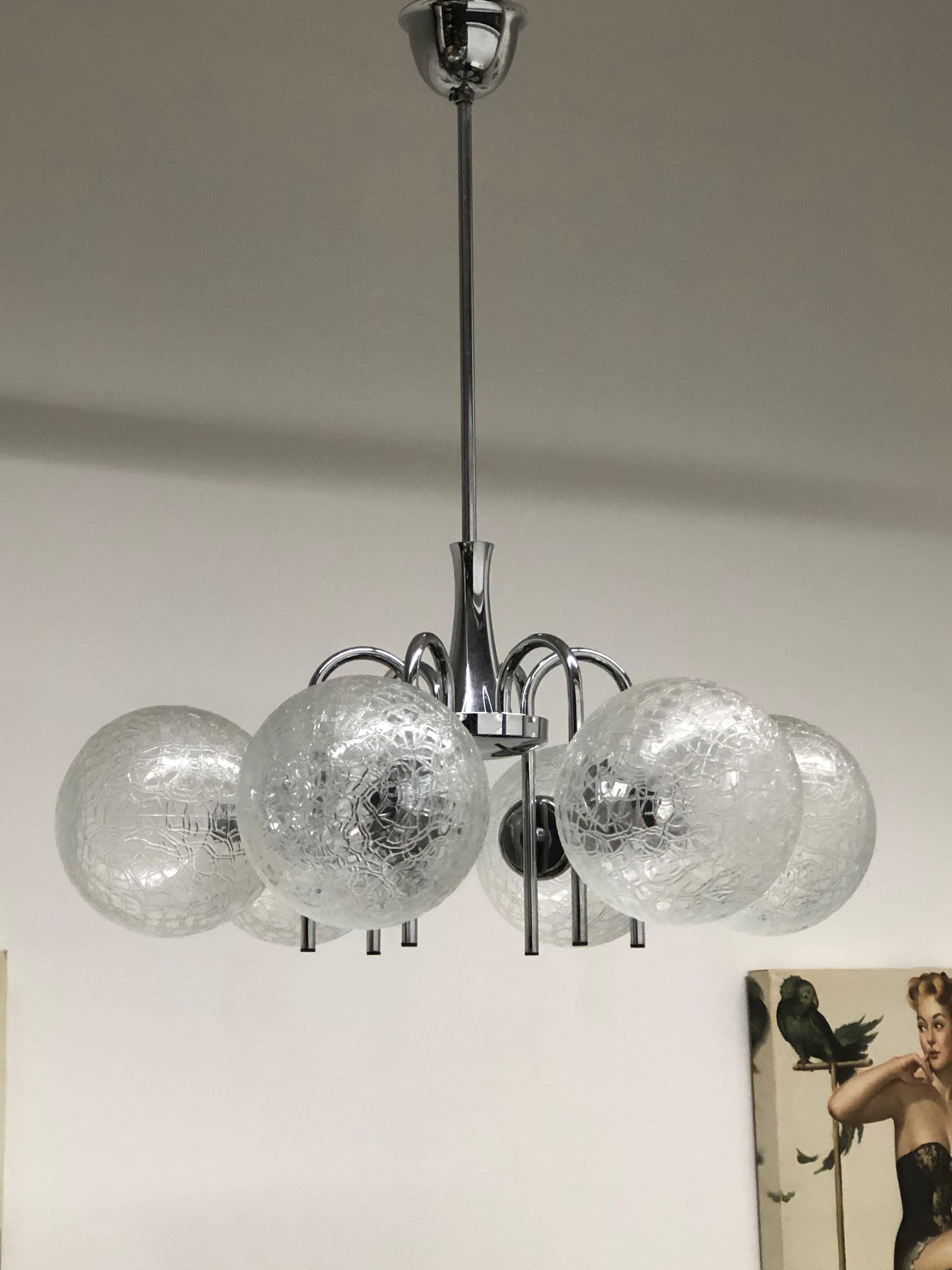 This Mid-Century Modern chandelier was made in the 1960s in Germany. It is made of six unique glass balls mounted on a chrome frame. The fixture requires six European E14 candelabra bulbs, each bulb up to 40 watts.