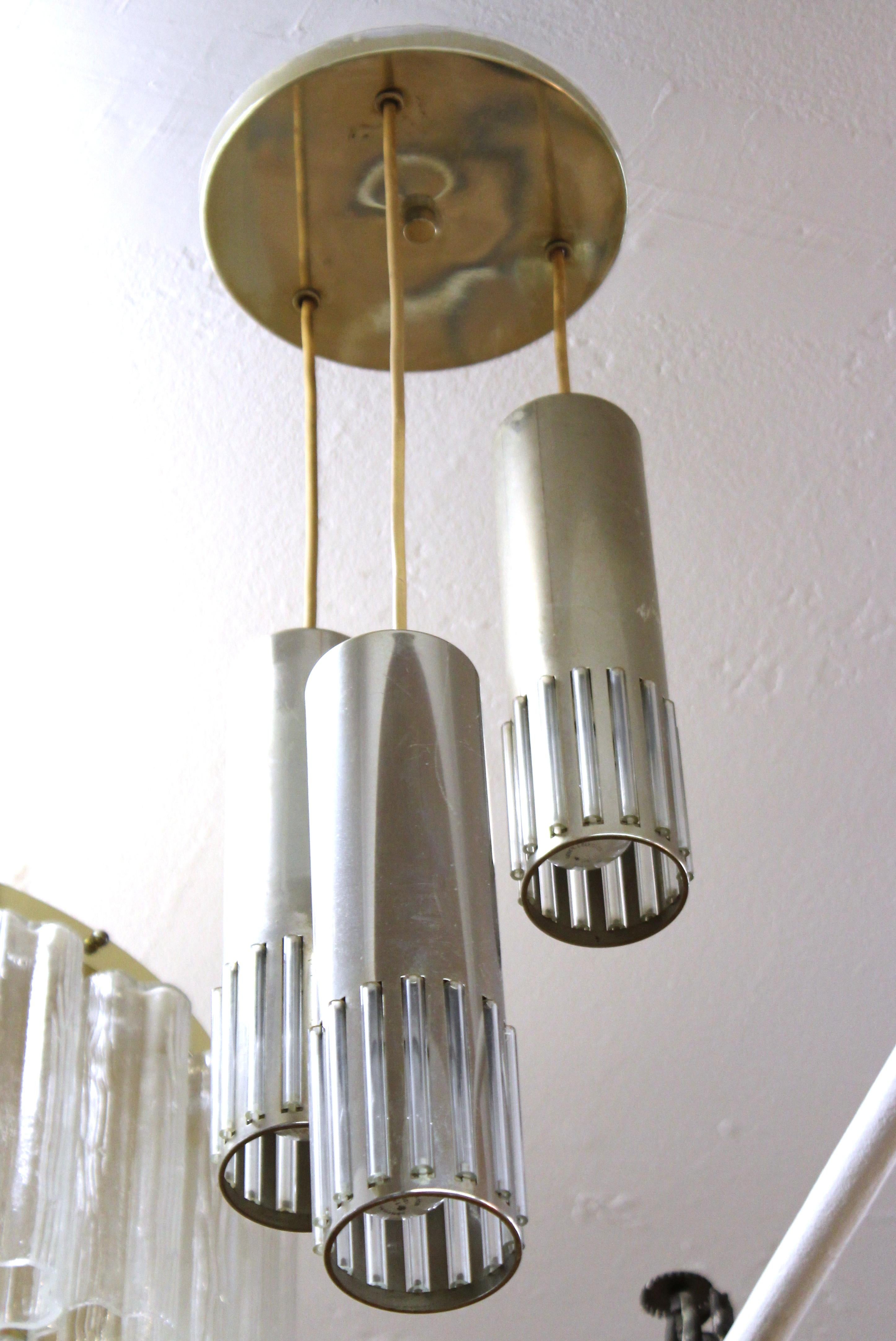 German Mid-Century Modern pendant light with three cascading tubular metal lights. Each tube has glass rod inserts on the bottom that refract the light from within. In great vintage condition with age-appropriate wear and use.