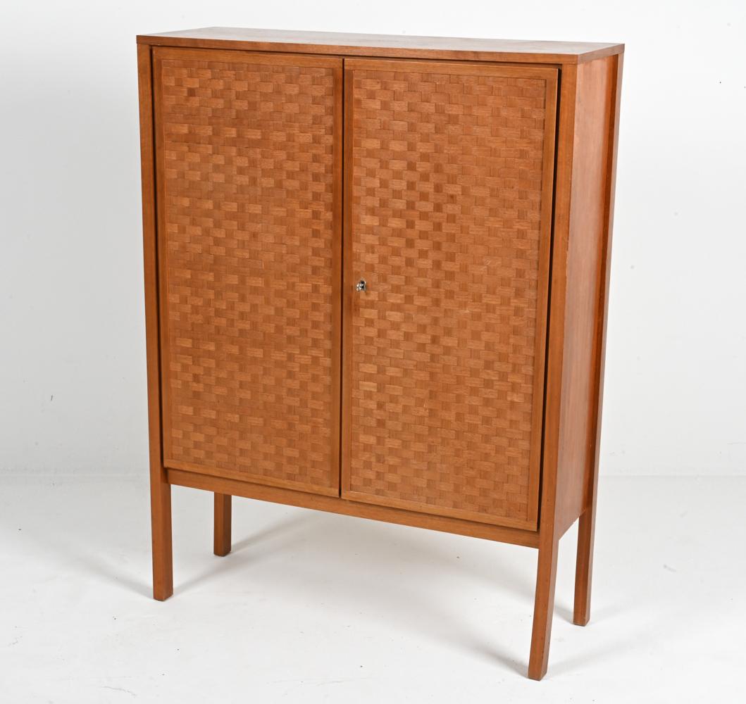 Presenting an exceptional teak highboy cabinet designed by the visionary Leo Bub and meticulously crafted in Germany during the 1960s. This timeless piece is a testament to Bub's innovative approach to design and the enduring appeal of Mid-Century