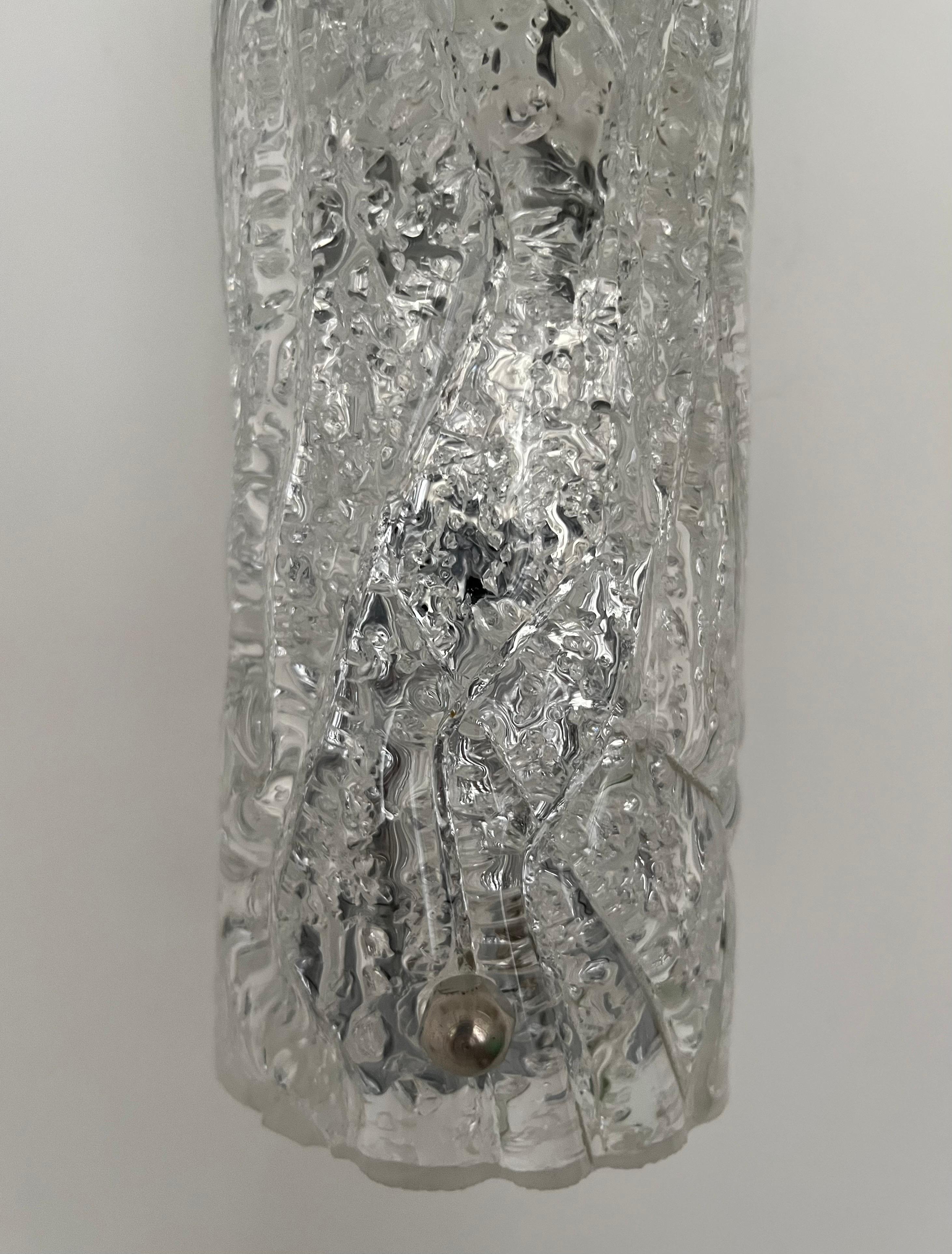 Stunning and beauty Pair of Murano Ice-glass Wall Sconces by Hillebrand Leuchten. These fixtures were designed and manufactured during the 1970s in Germany. Model 8527-211.
Each Wall Sconce is composed metal structure and a piece of Murano glass.