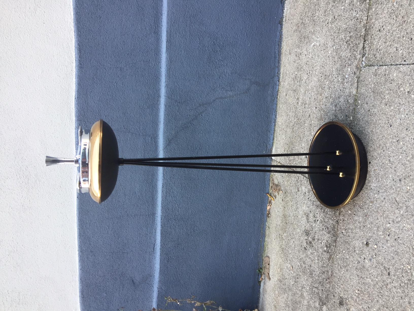 A decorative floor ashtray that resembles a UFO prior to landing. Its fashioned out of black painted iron and has brass detailing. The ashtray itself is easily removable and is made of stainless steel. It was manufactured in Germany during the early