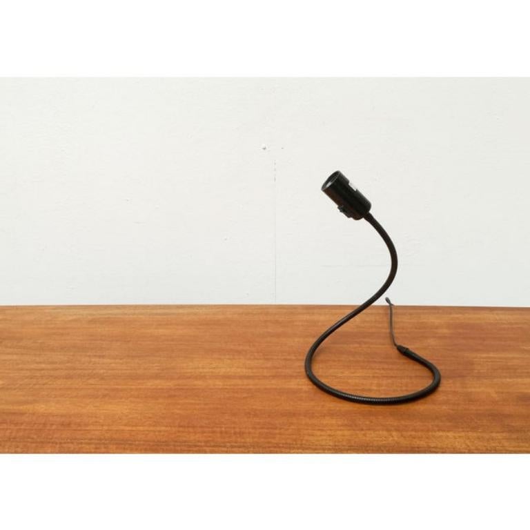 Lámpara de mesa atemporal del fabricante tradicional Tecnolumen según un diseño de Walter Schnepel de principios de la década de 2000.

Un diseño sencillo y atemporal. La luminaria consiste en una manguera metálica flexible en la que se asienta una