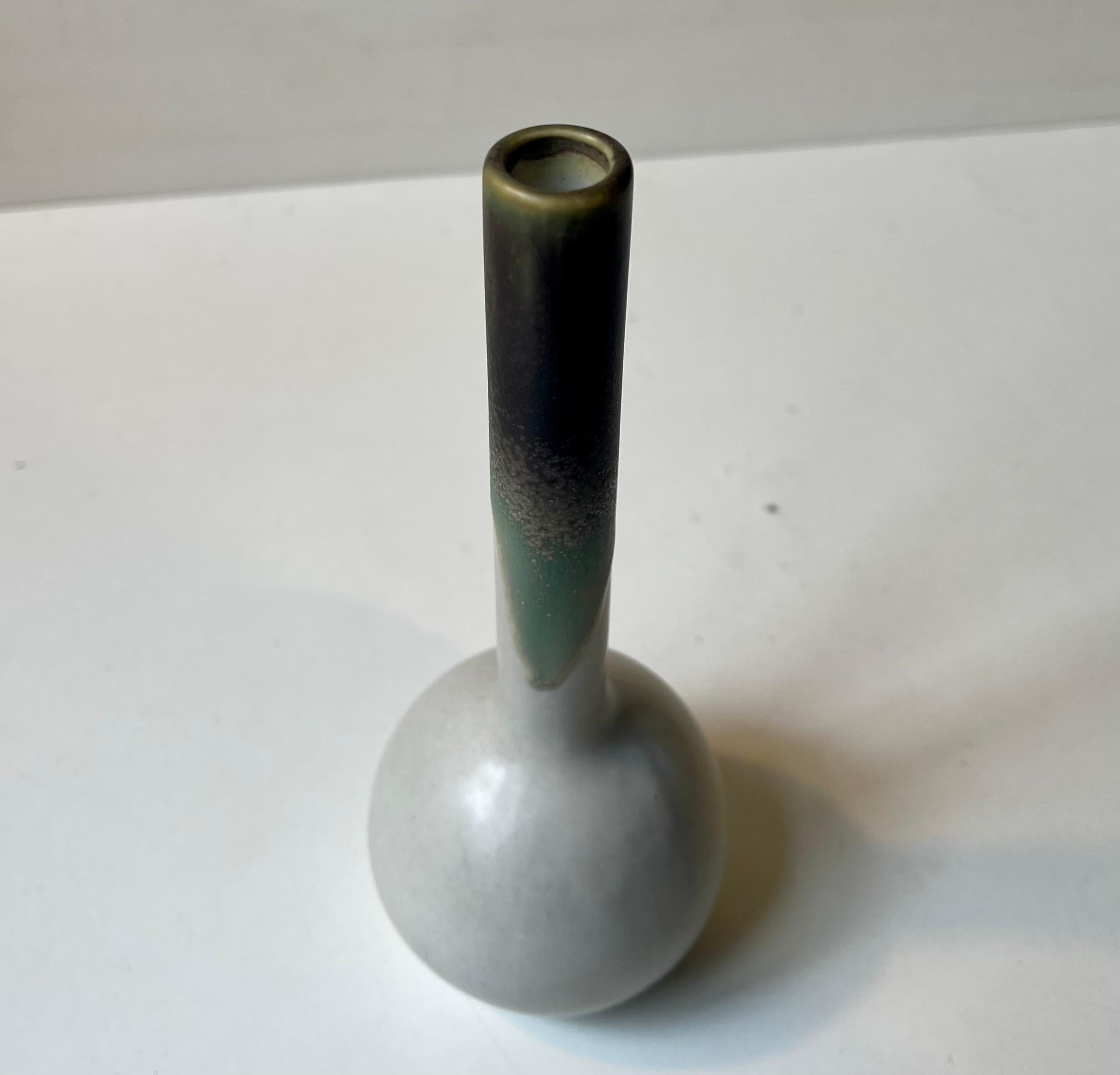 Small long neck ceramic vase decorated with green and brown earthy drip glazes. Dessin 3037 by Peter Müller for Sgrafo Atelje in Germany circa 1970. Reminiscent in style to Franchi Assisi. Measurements: H: 18,5 cm, D: 8 cm at it widest point.