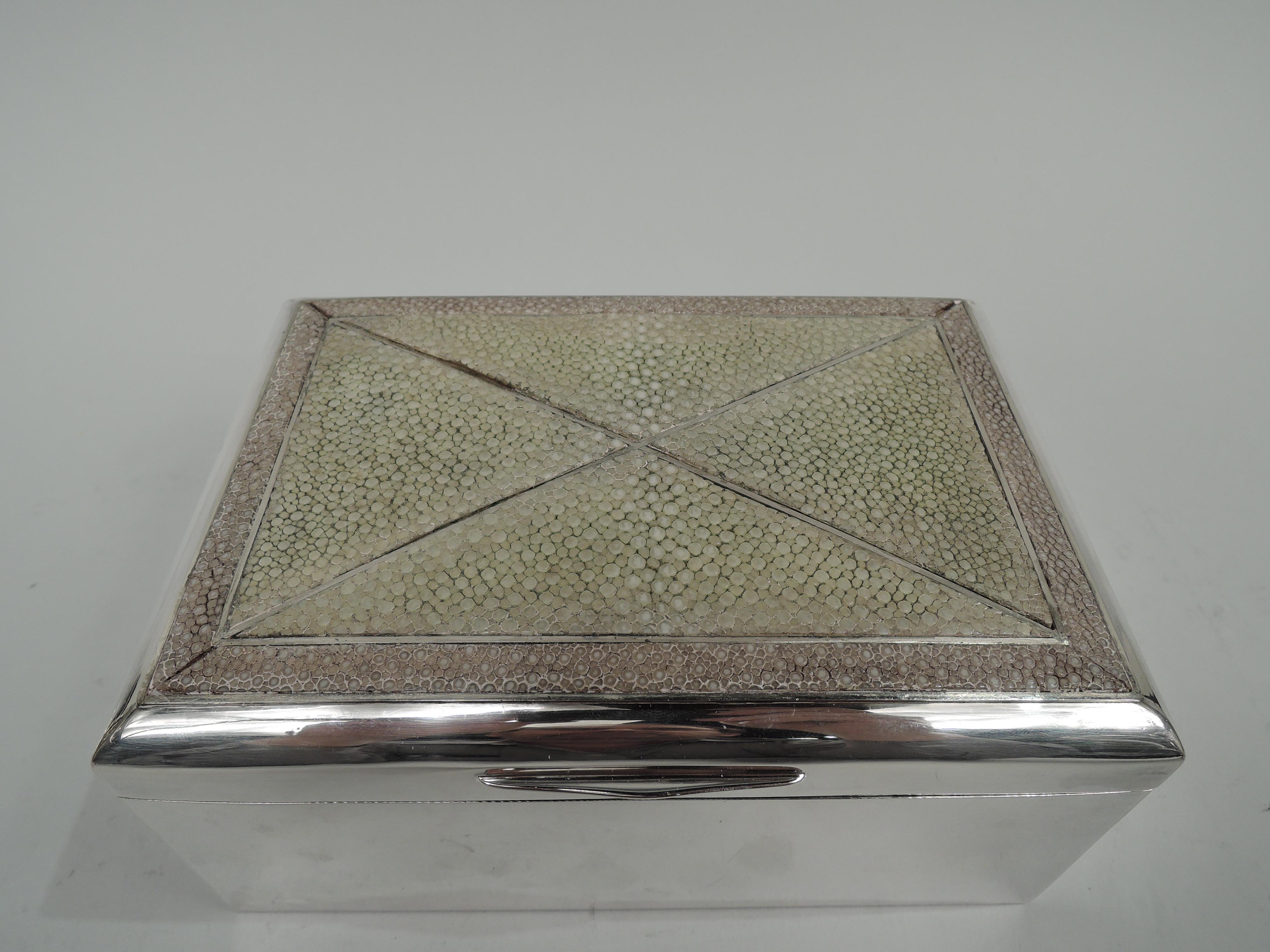 German Modern 800 silver box, ca 1920. Rectangular with straight sides and crisp corners. Cover hinged with tapering tab; cover top gently curved and inlaid with shagreen in geometric pattern. Cedar-lined interior. Open leather-lined bottom. Marks
