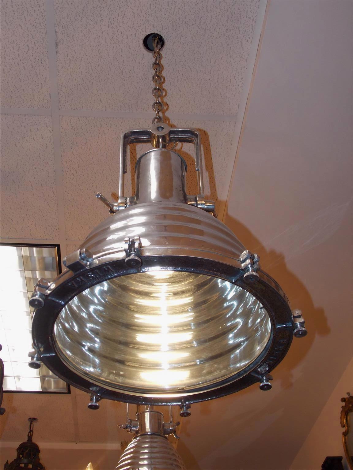 Single German nautical aluminum hanging ship cargo light with hinged yoke, rippled cowl, and original glass. Light is marked Wiska on bezel and has been recently rewired, 20th century.
 