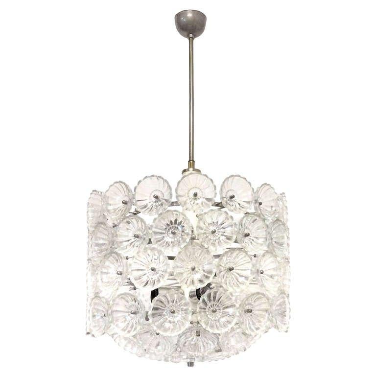 A chandelier with multiple concave glass flowers attached to a nickel frame.

German, Circa 1960's
