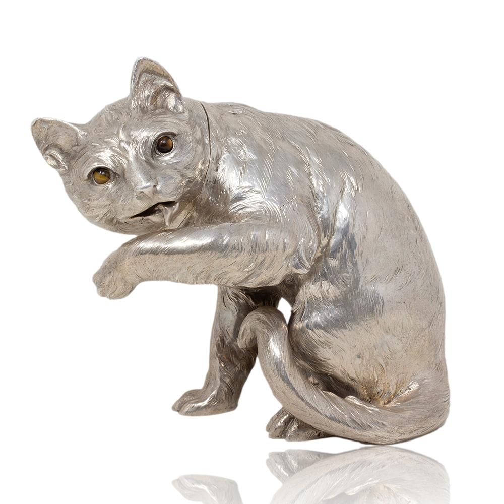 From our Silver collection we are delighted to offer this rare German Silver Cat by Ludwig Neresheimer & Co.

The cat is modelled in a naturalistic pose, humorously shown cleaning itself with one paw raised and its tongue out while looking alert.