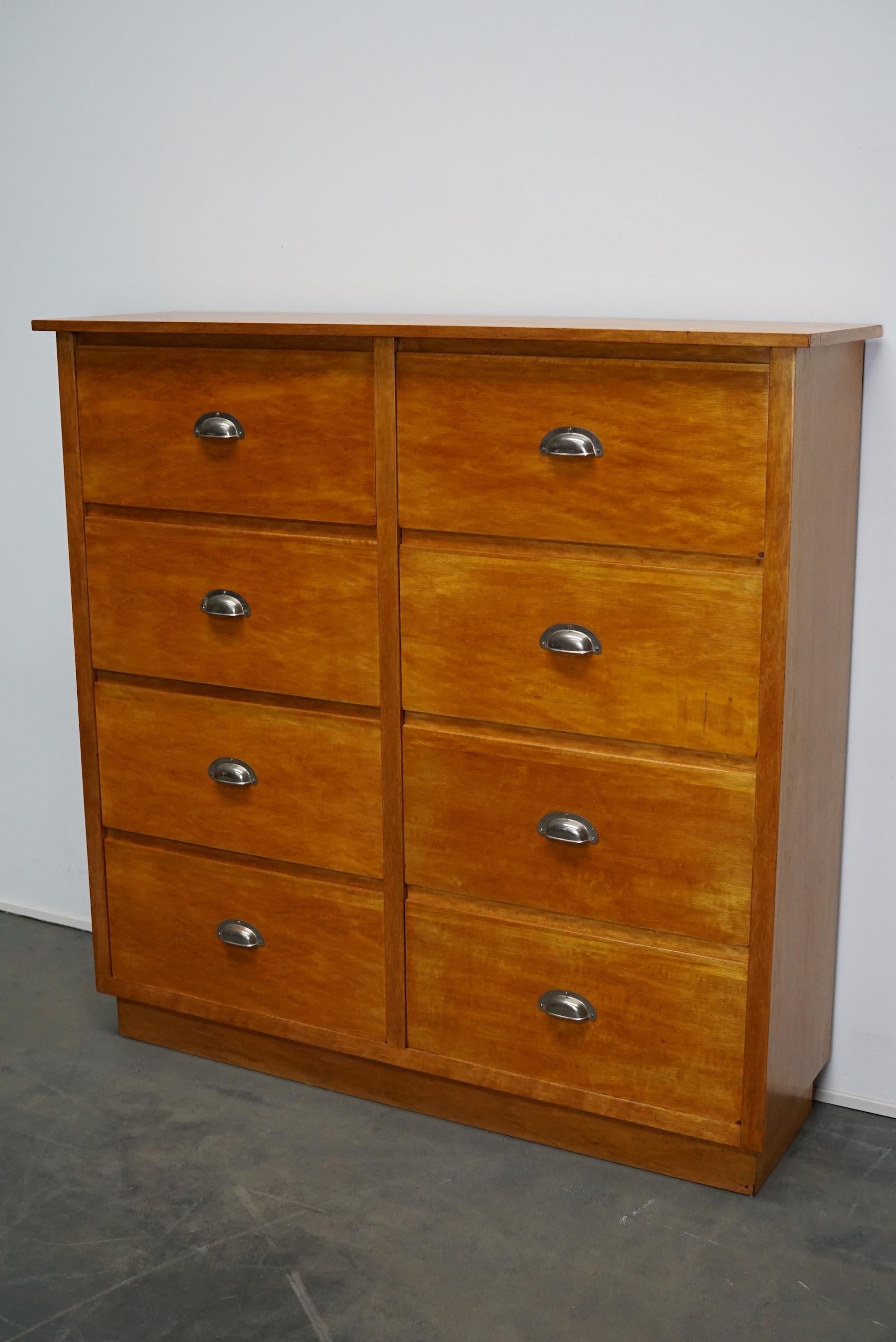 This apothecary with large drawers was made circa 1950s in Germany. It features 8 drawers with sheet metal cup handles. It remains in a good restored condition. The interior dimensions of the drawers are: D x W x H: 28 x 50 x 23 cm.