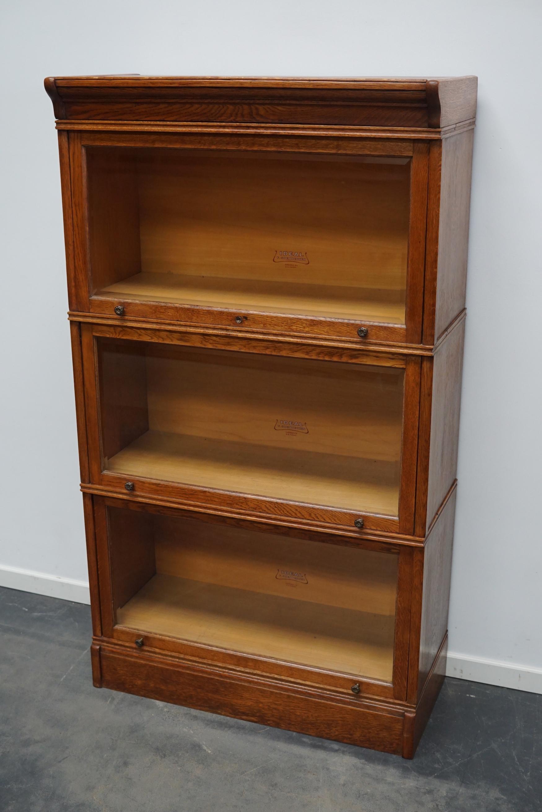 This bookcase was produced by F.Soennecken in the Germany around 1900. It features 3 stackable large compartments with cut glass sliding doors. The interior dimensions of the compartments are: DWH 30 x 82 x 36 cm.