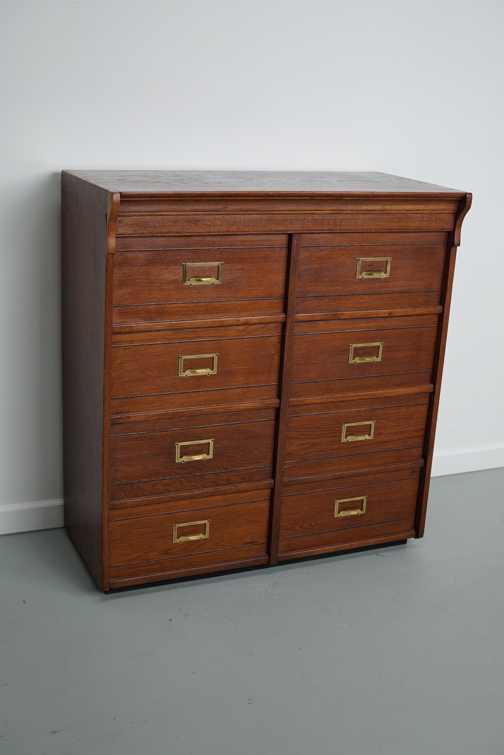 This oak filing cabinet with brass hardware was made around the 1920s in Germany by the company F.Soennecken. The interior dimensions of the compartments are: D W H 34 x 37 x 13 cm.