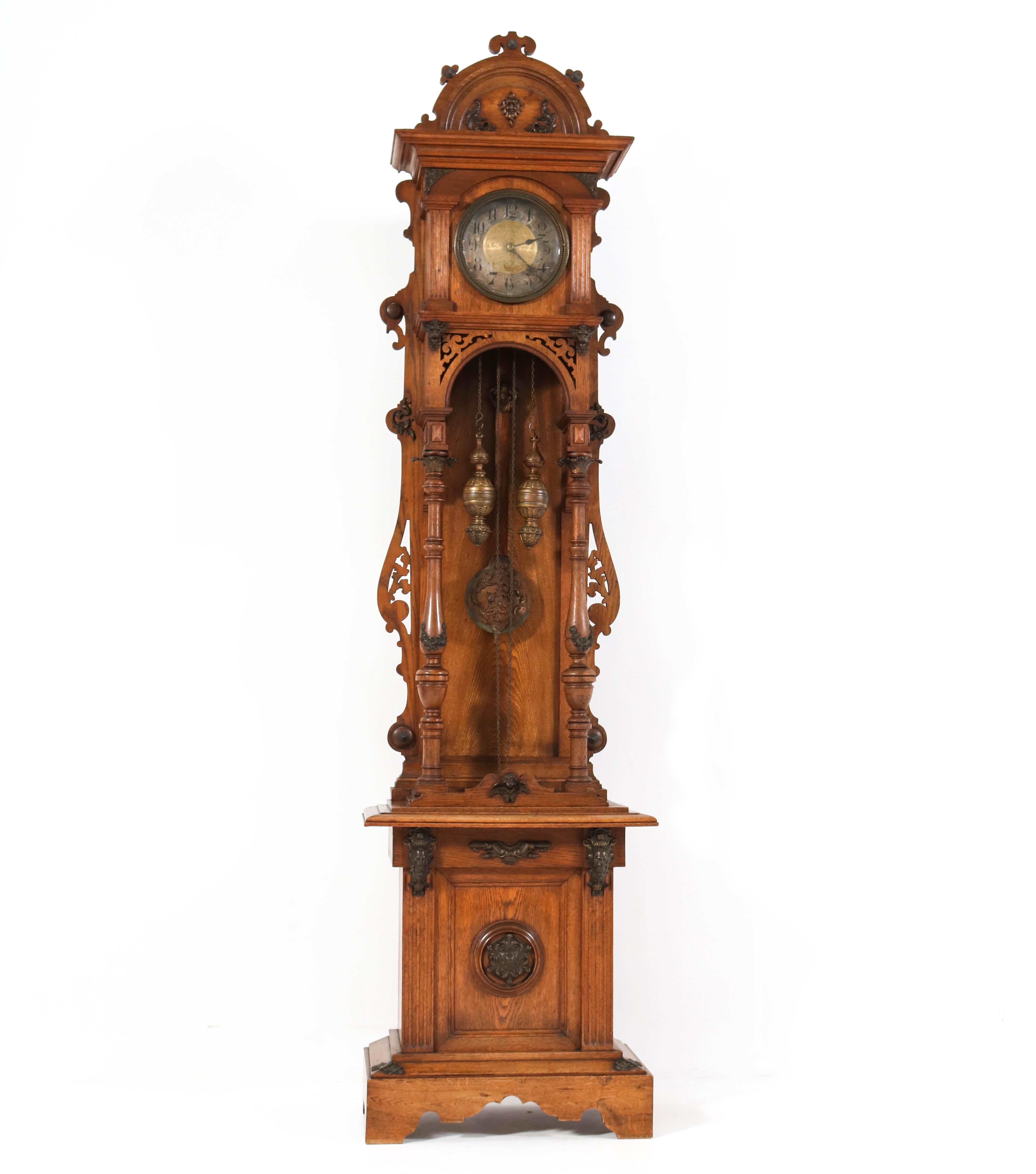 Magnificent and rare Gründerzeit Grandfather clock.
Striking German design from the 1880s.
Solid oak open ornate case.
Weight-driven movement.
Ornate brass weights.
Nice hand-made carving and brass decorations.
In very good original condition