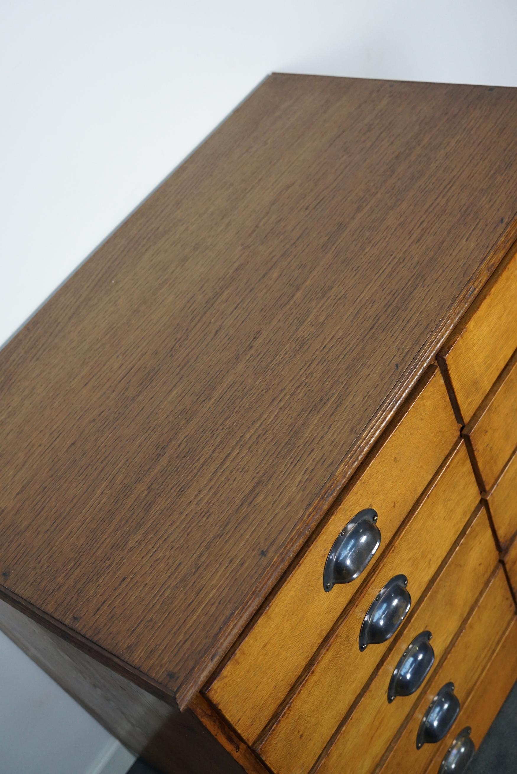 This apothecary cabinet was made circa 1940s in Germany and was later used in a hardware store in Belgium until recently. It features 10 drawers with nice brass handles. The interior dimensions of the drawers are: DWH 45 x 35 x 8 cm.
 