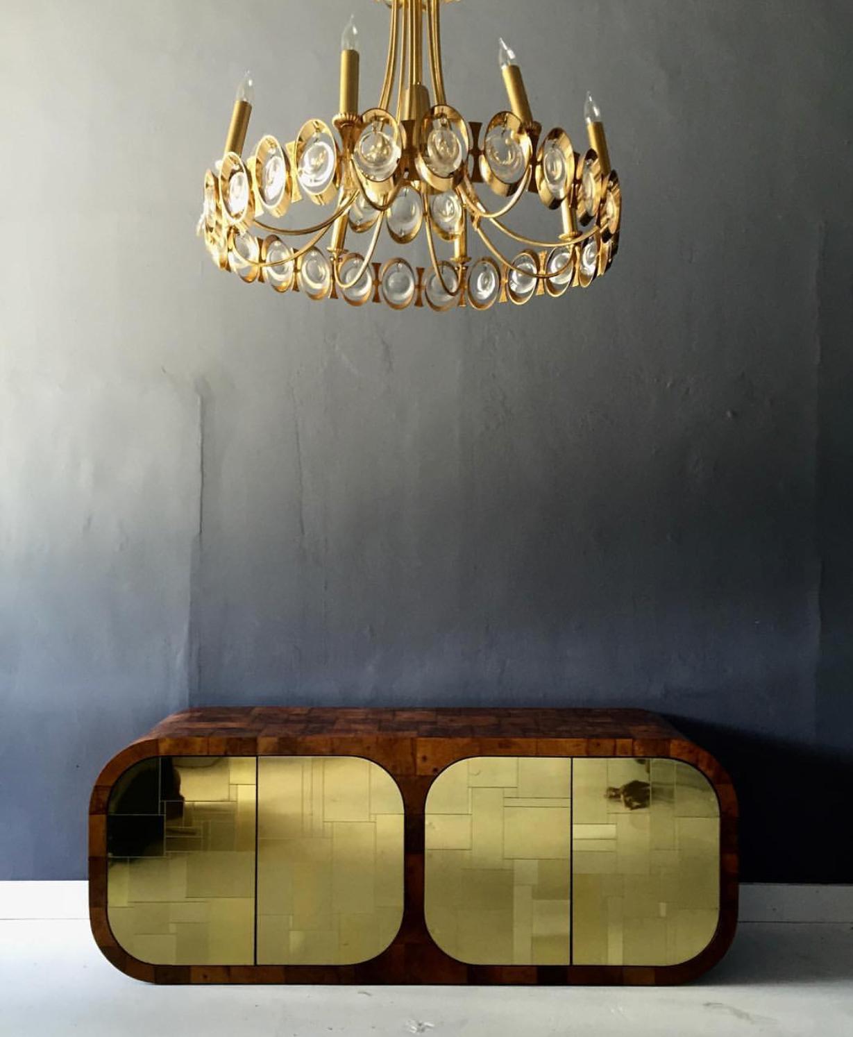 A stunning eight-light chandelier with a central down light, made by Palwa in Germany circa 1960s. The piece is of Hollywood Regency high glamour style with 24K gold plated brass and crystal discs. Inspired by a classic form but infused with 60s