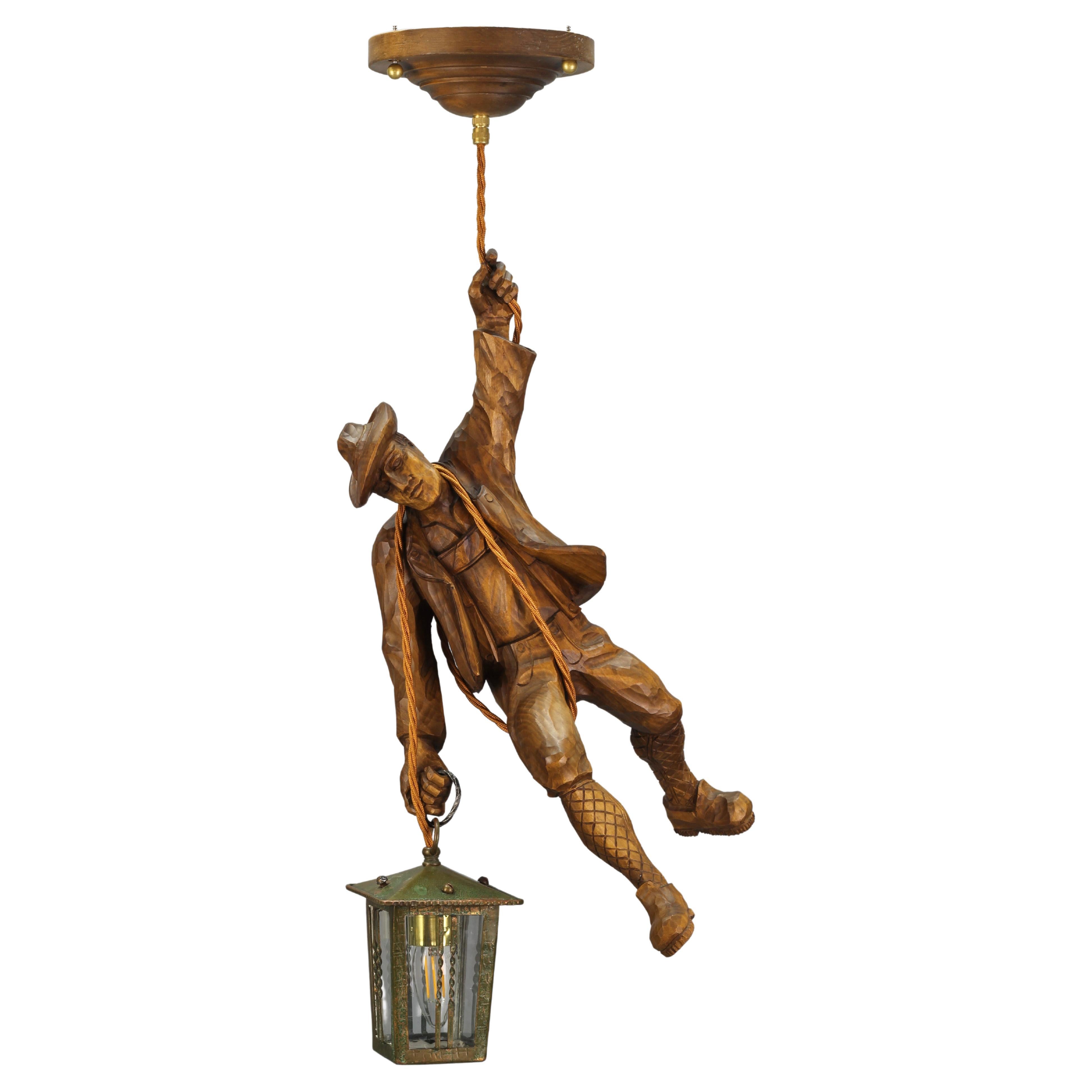 German Pendant Light with a Carved Wooden Figure of Mountain Climber and Lantern For Sale