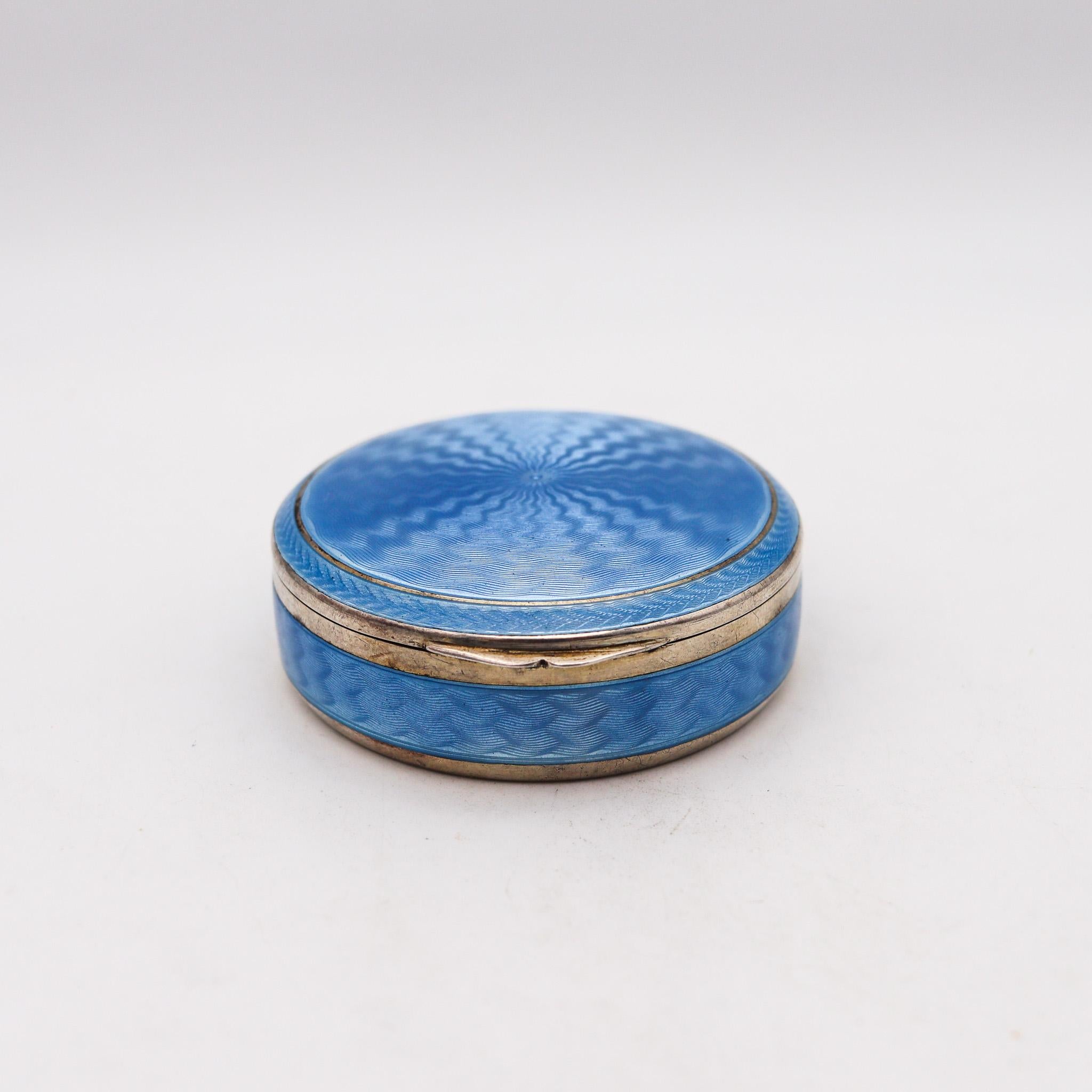 A guilloche enameled round box.

Fabulous German early 20th century enamel box, created in Pforzheim Germany, circa 1920. This beautiful box was carefully crafted at the workshop of E&W, with impeccable details in solid .935/.999 standard silver
