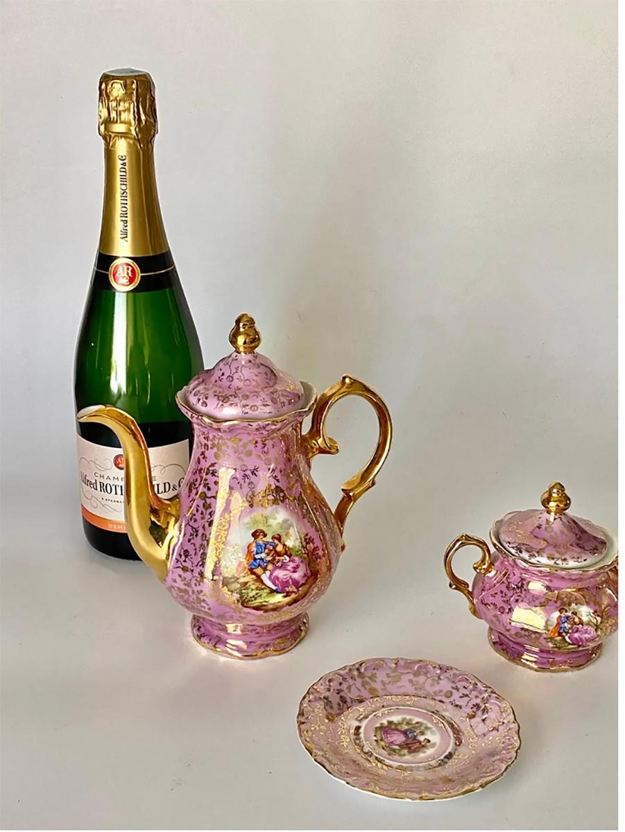 These are 3 pieces of a coffee service. The colors are Pink and Gold.
1 Sugar pot
1 Coffee cup plate
I TeaPot or coffeepot
The are from Germany. the mark is underneath.
  
