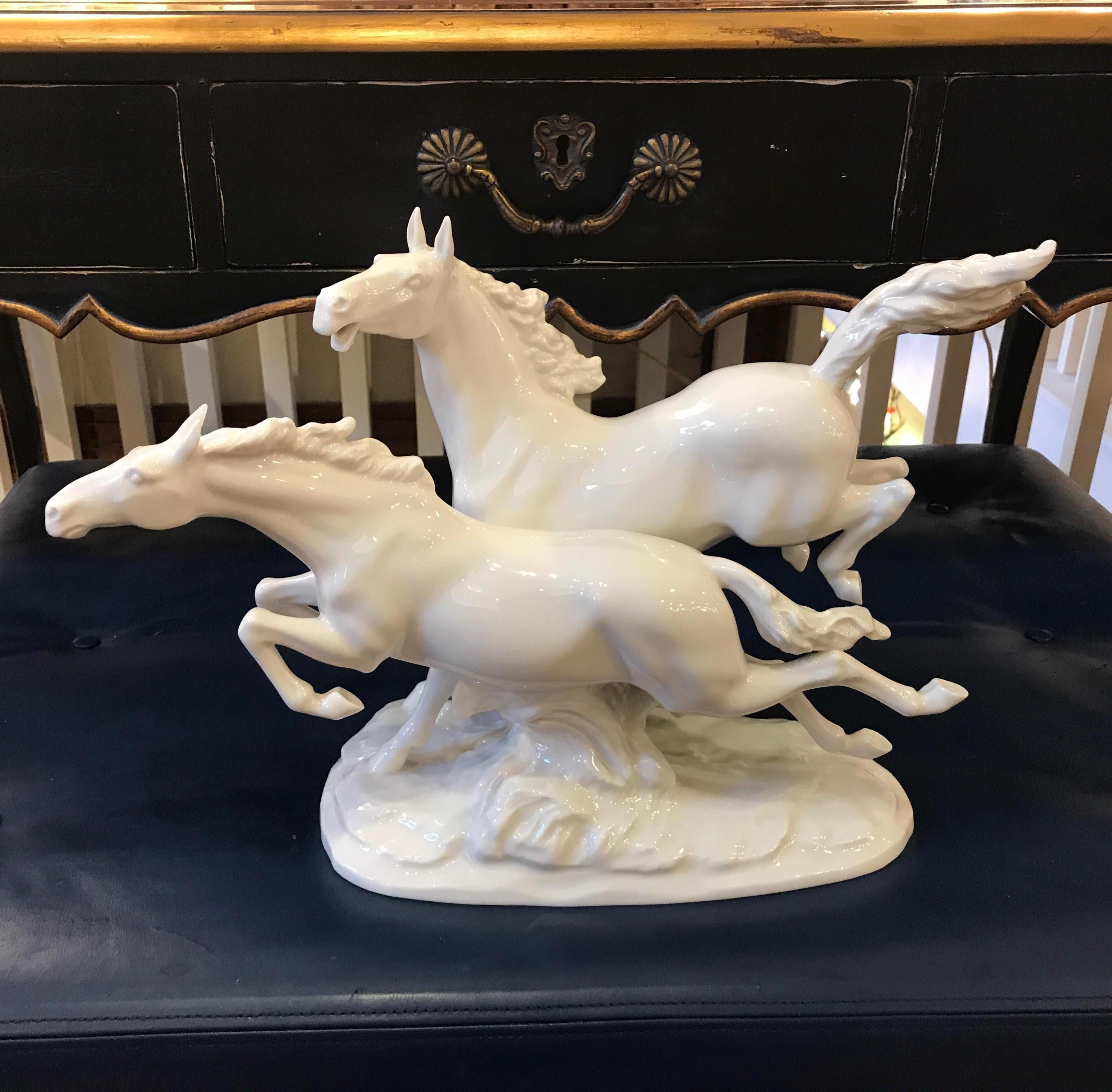 Graceful blanc de chine porcelain horses, Germany, circa 1930s. The pair of horses with flowing manes and tails on an oval textured base. Marked on underside, Hutschenreuther.