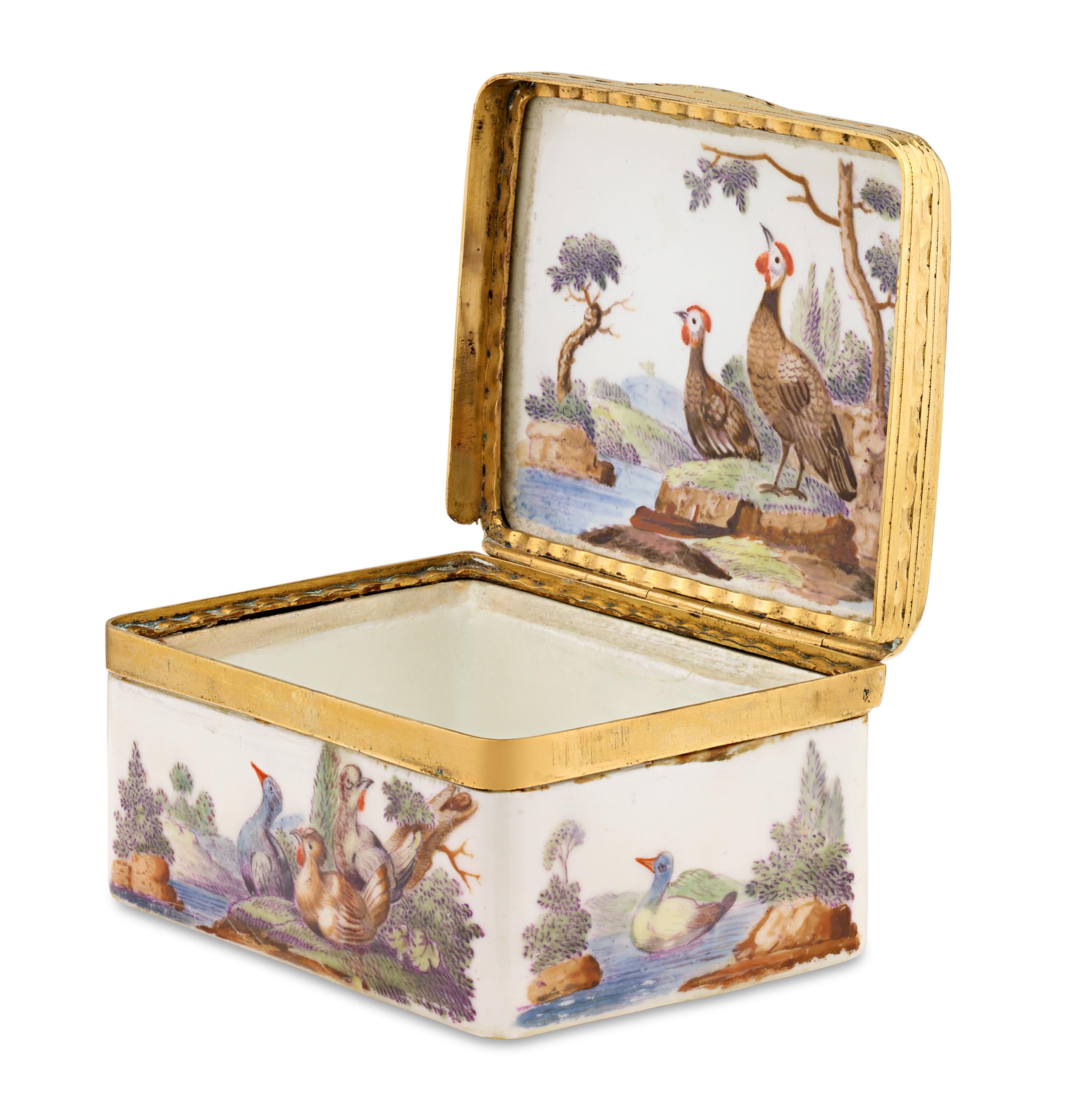 This important German porcelain box exhibits delightful artistry and craftsmanship. Its hand-painted wild game scene celebrates the natural world, while bronze gilt and 16k gold mountings beautifully complement the vibrant colors and intricate