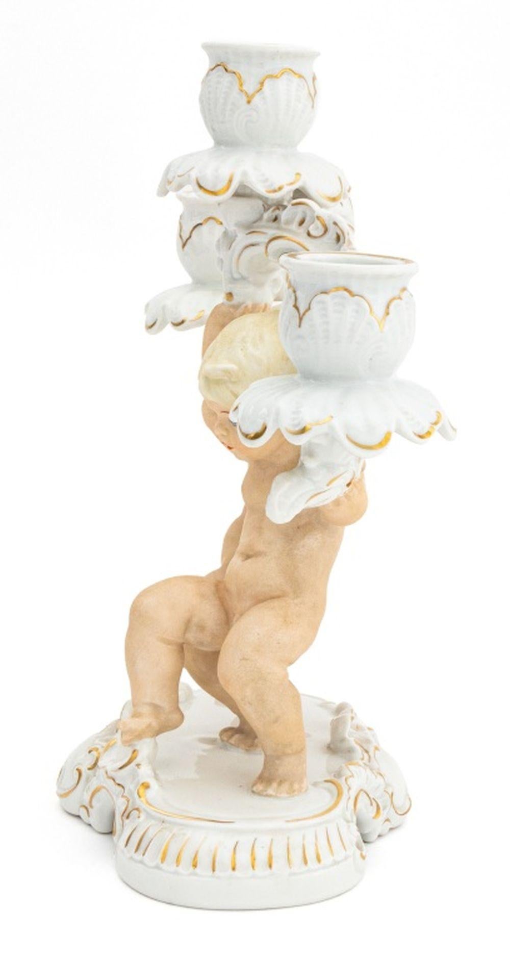 Two German Porcelain Cherub Motif Candelabra, one Hutschenreuther white glazed two-light candelabrum, with impressed 