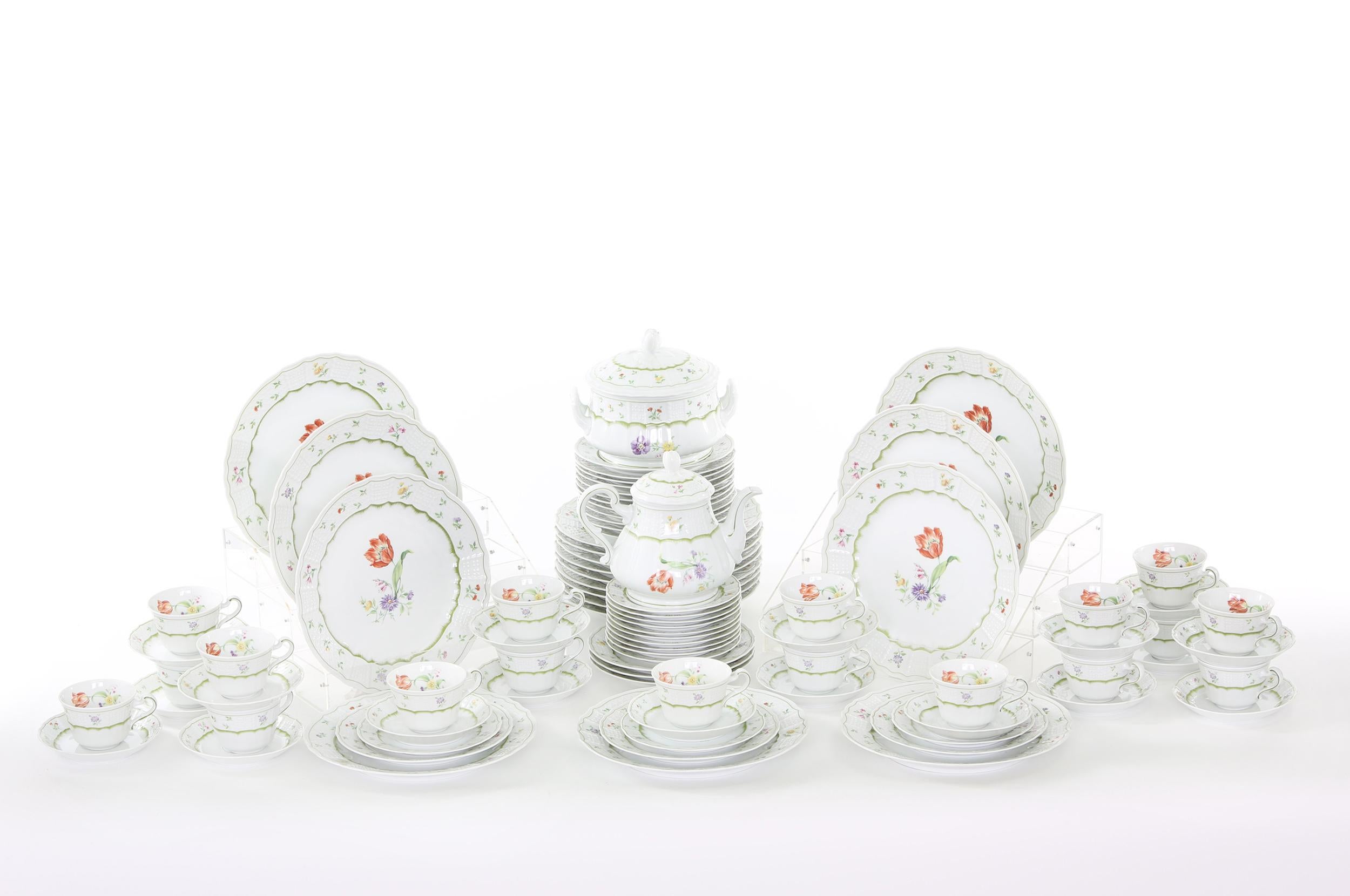German porcelain dinnerware service for eighteen people with serving pieces. Each piece is in great condition. Maker's mark undersigned 