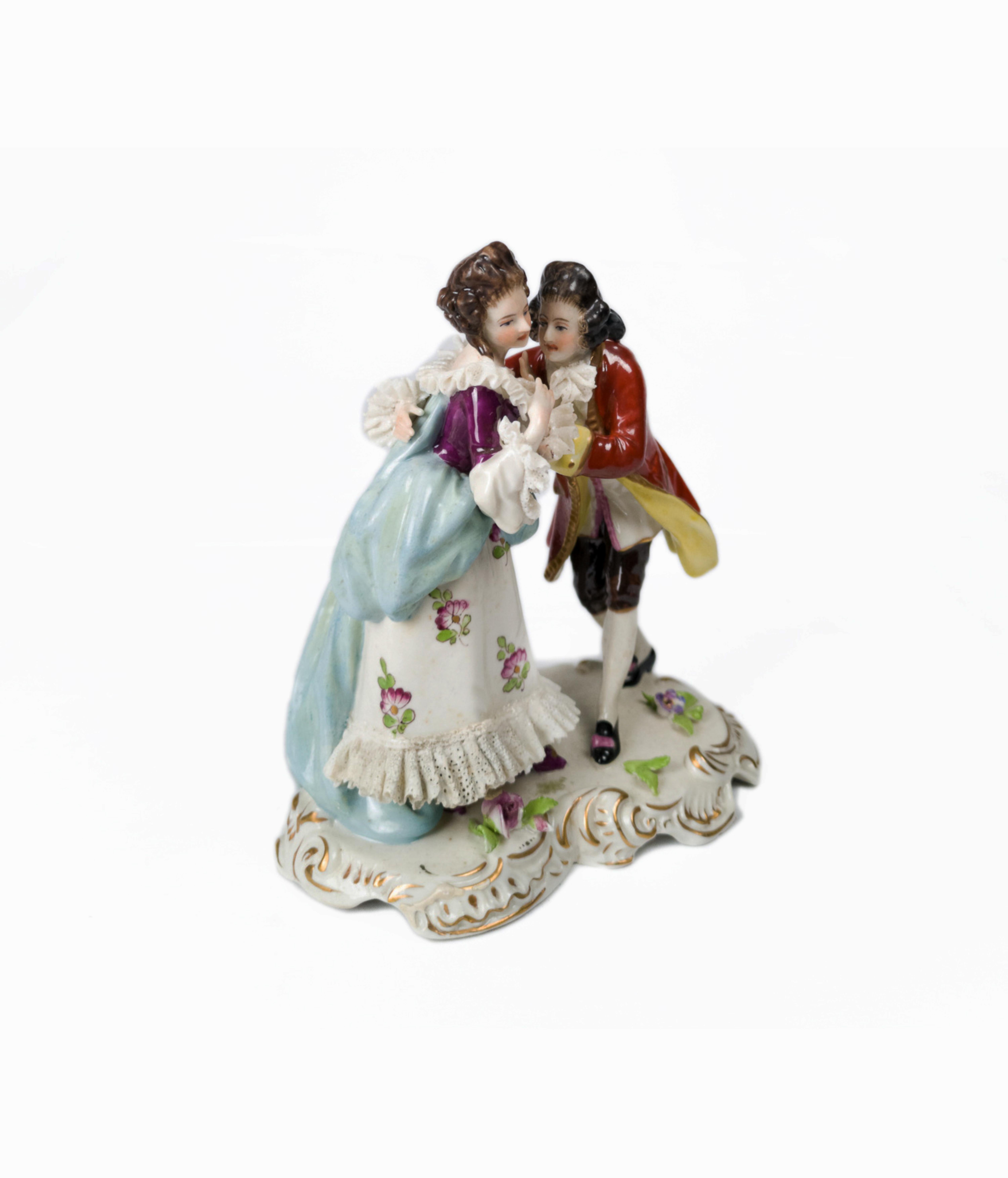 A porcelain figure of a kissing couple, a very fine soft piece from Volkstedt with a mark on the base and the date 