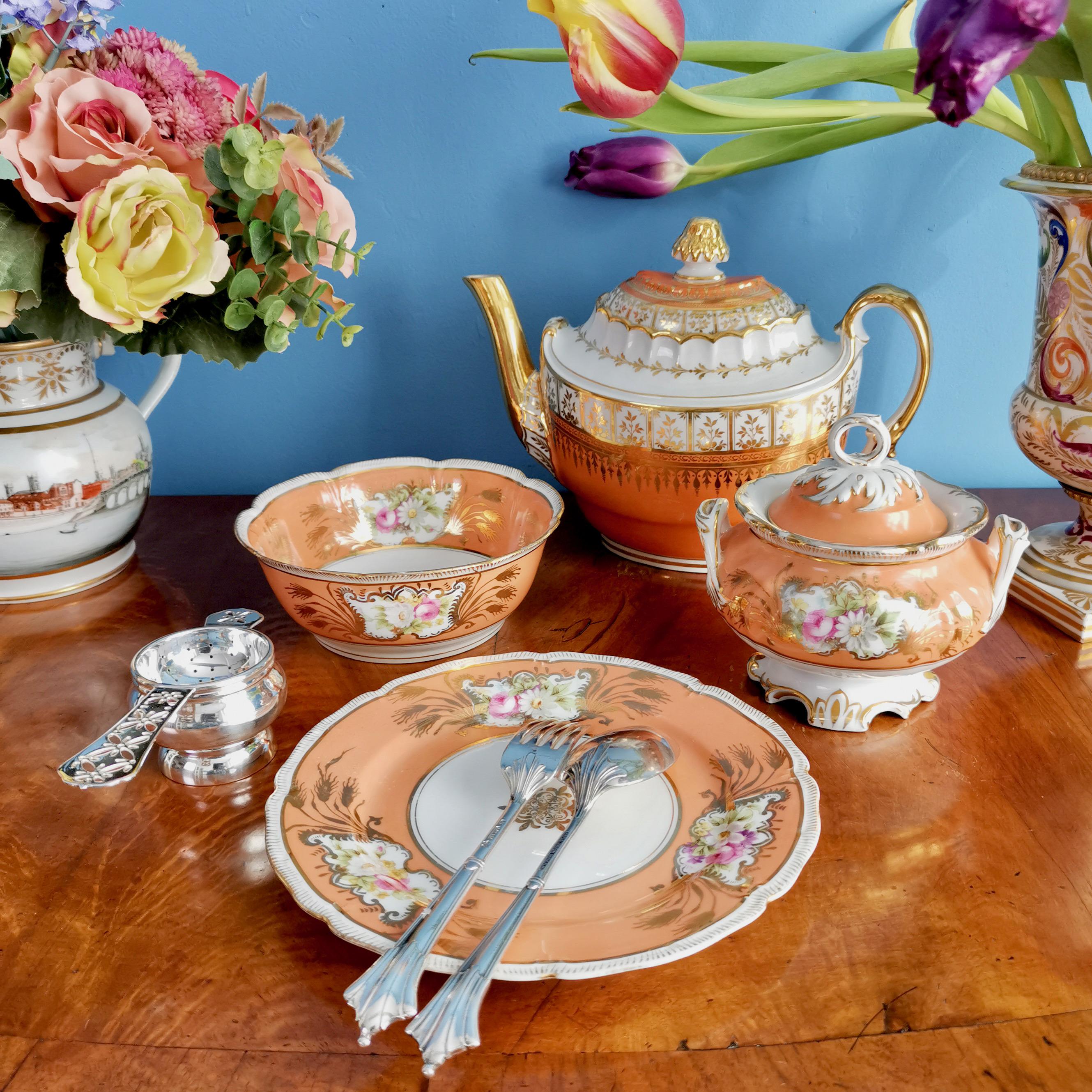 This is a very charming set of a sucrier or lidded sugar box, a bowl and a plate, made in Germany in about 1860. The set is made in the Rococo Revival style. It has a beautiful warm orange ground with flowers and 