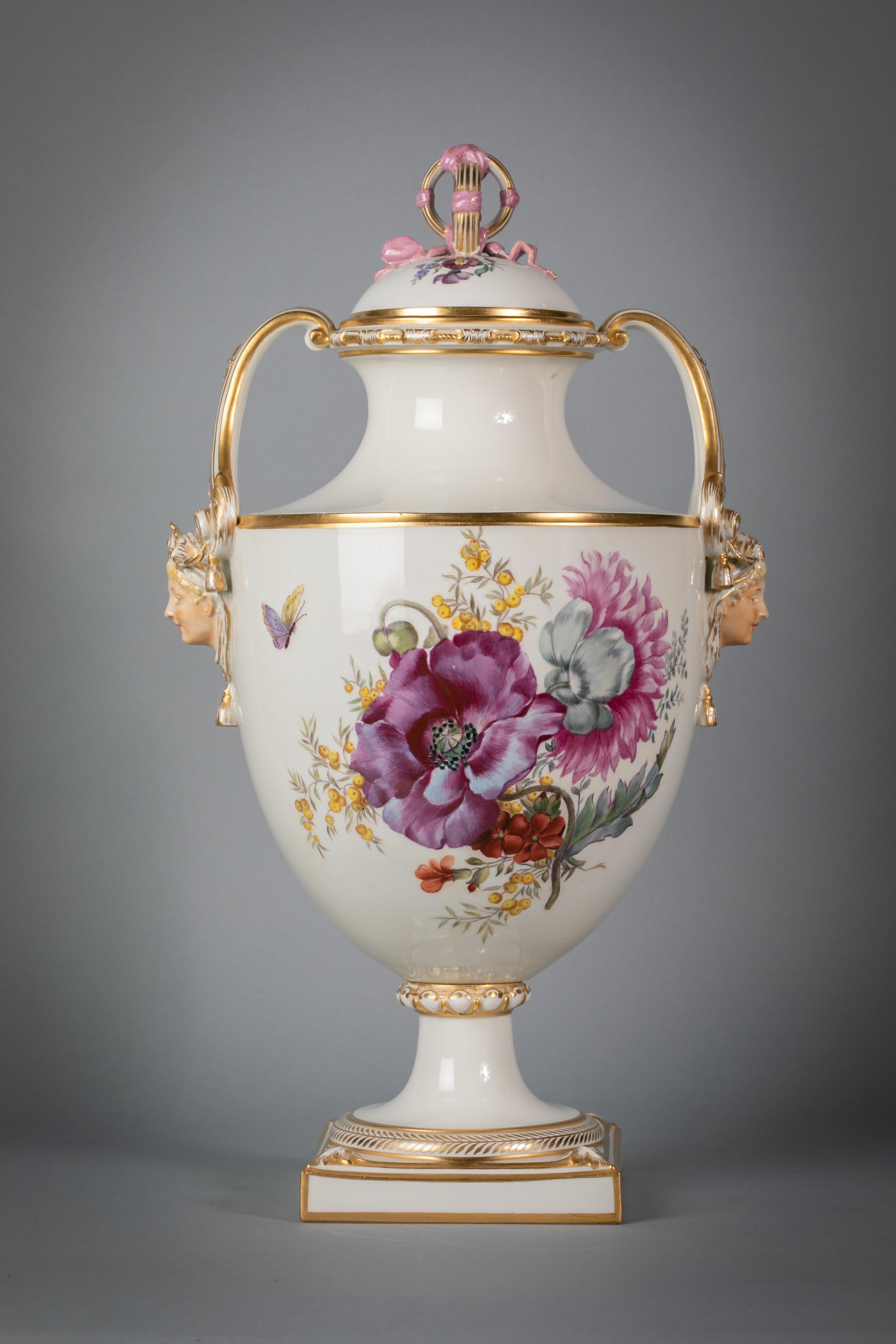 Painted on both with large floral bouquet, with masked handles and the cover similarly decorated with looped finial. With under glaze blue canceled mark.