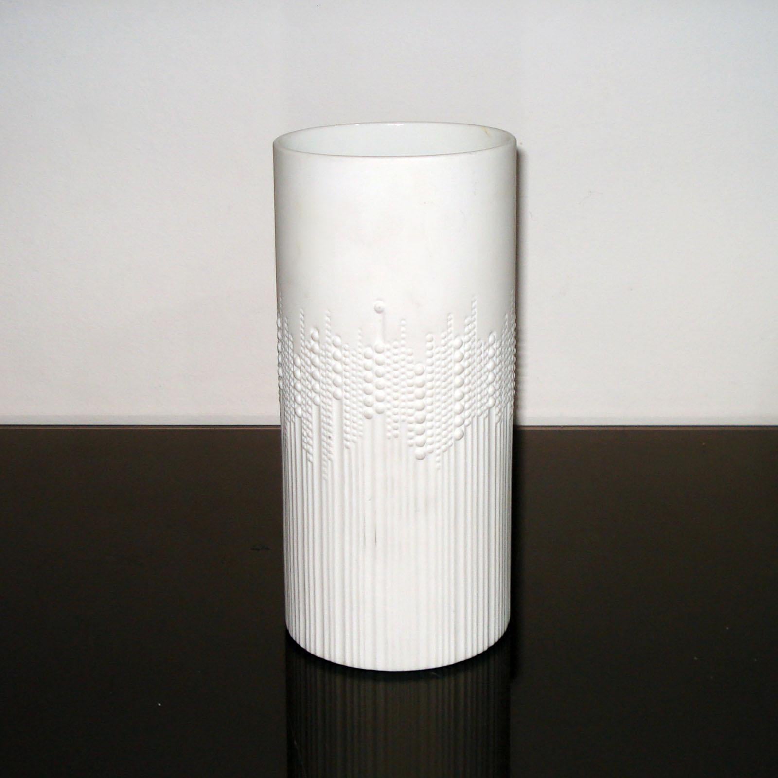 A tall, ovoid shaped white porcelain vase designed in 1970 by Tapio Wirkkala for Rosenthal Studio Line ‘Drops’ pattern as the tactile design on its exterior has raised dots, like rain droplets, against grooved channels. Matte finish exterior with a