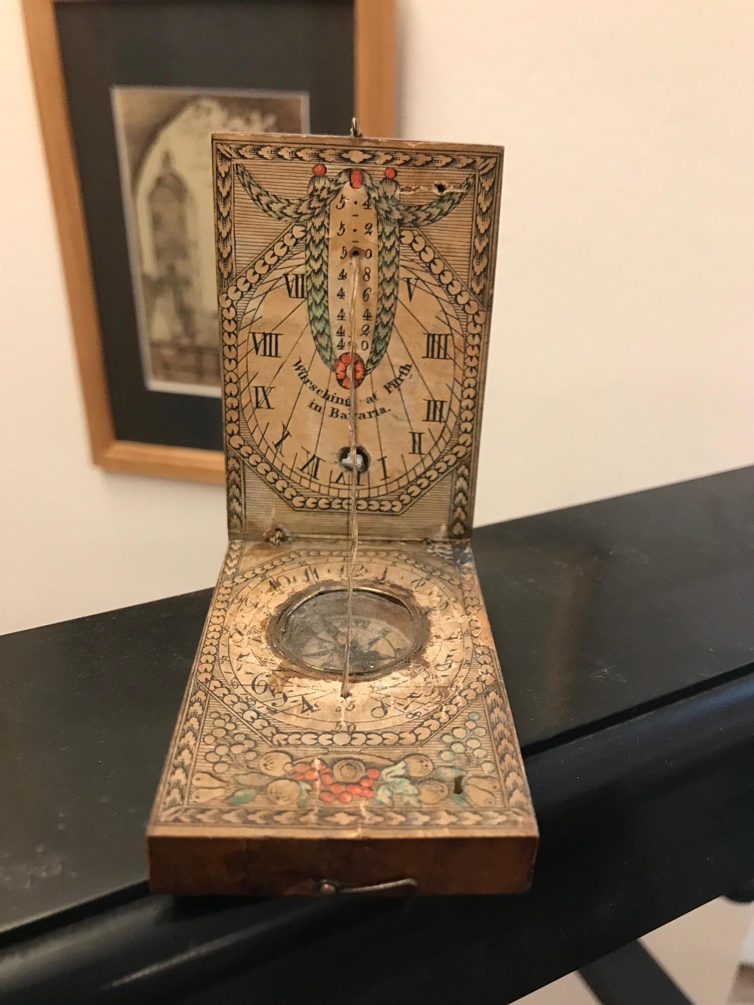 Portable sundial with functioning compass.
Some wear due to usage. With build in compass. Producer Würsching (second quarter 19th century) Origin Fürth in Bavaria. Dimensions: open: 11.3 × 7 × 11 cm (4 7/16 × 2 3/4 × 4 5/16 in. Materials: wood,