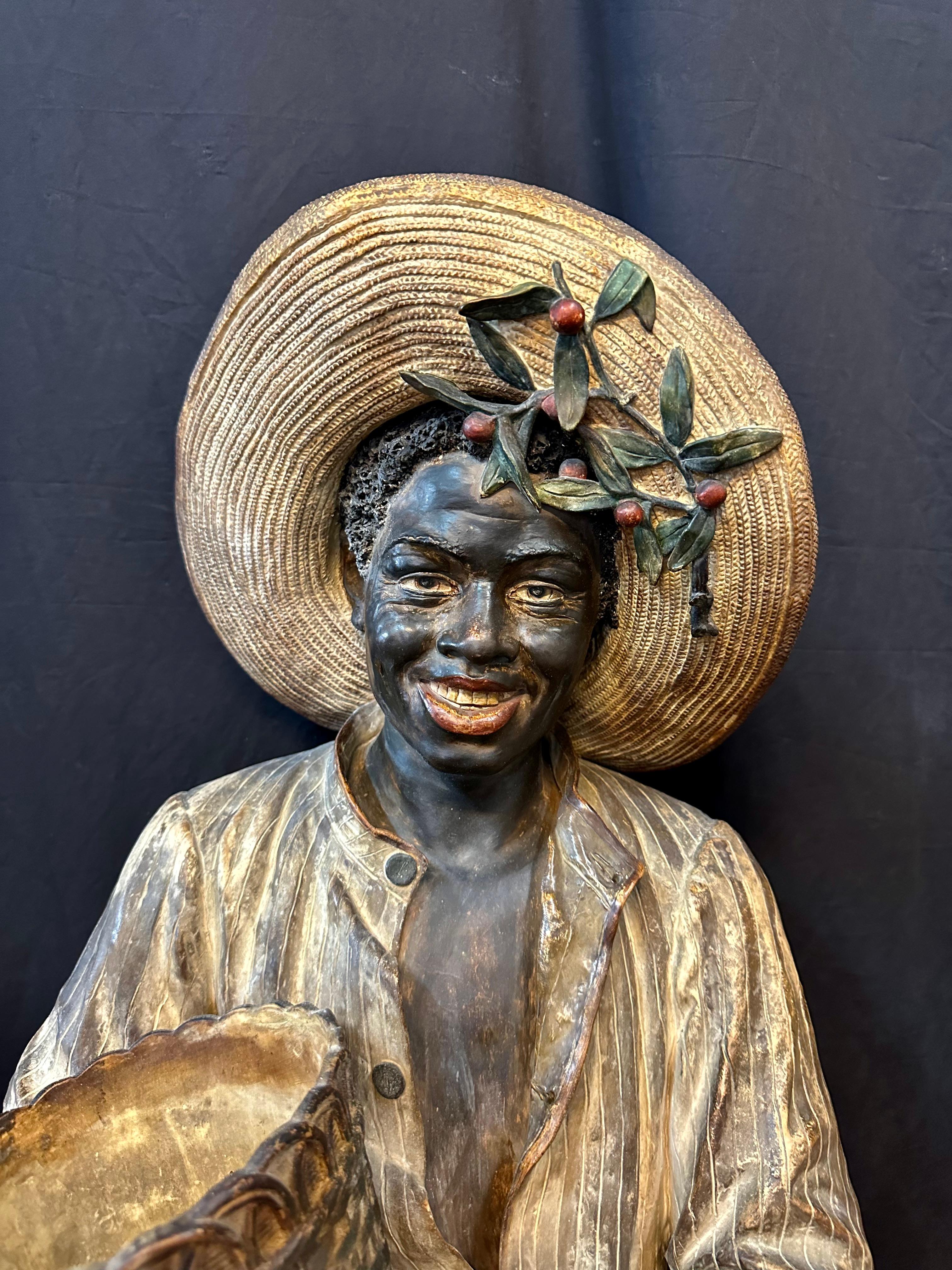 This rare vintage German made sculpted bust is beautifully hand painted & dates from the early 20th century. It is a high quality terra cotta portrayal of a young black boy/man, impressively detailed with life-like facial features & strong muscular