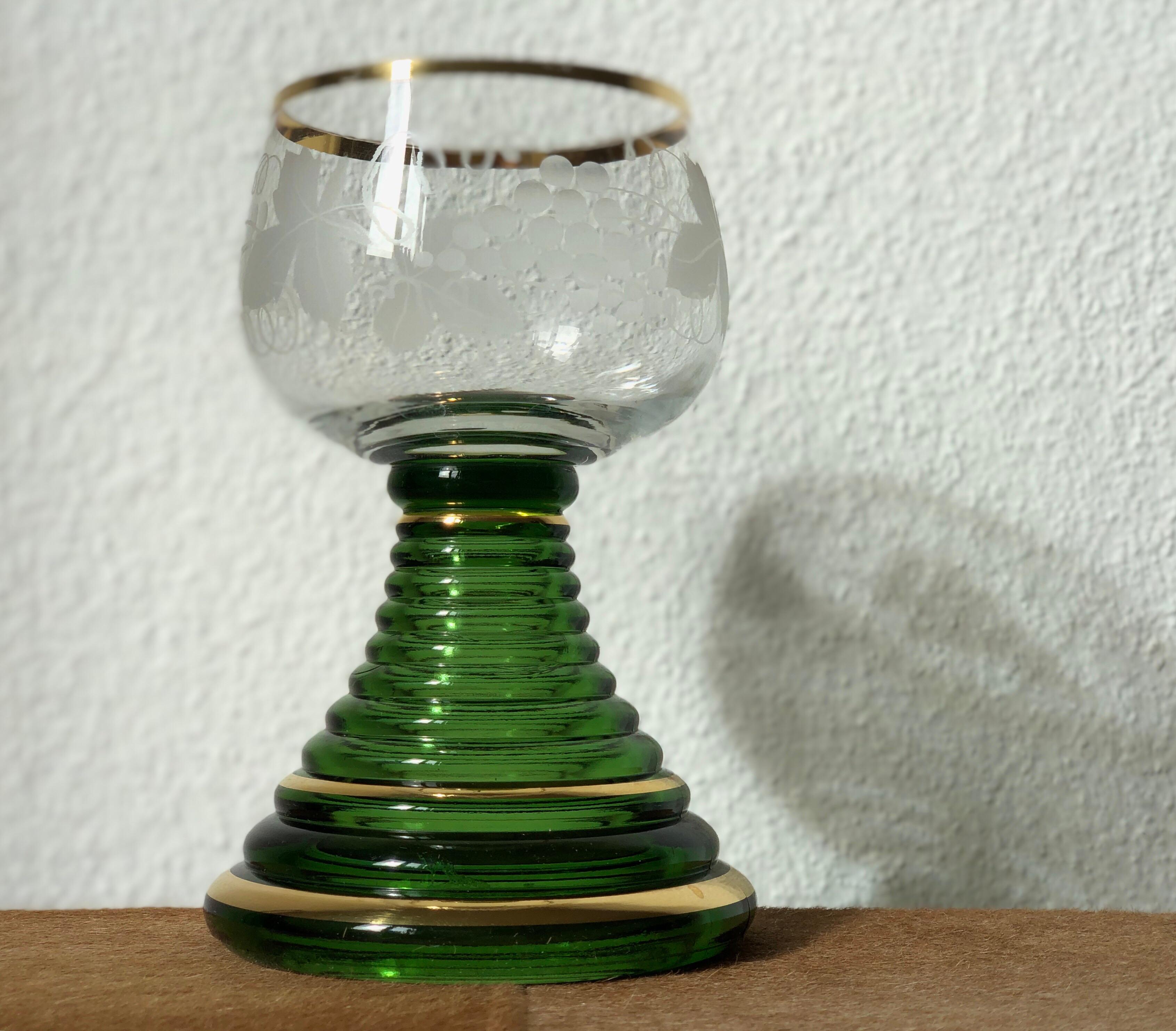 These traditional German Wine Glasses with a green stem are all-over Germany, where they are used to serve sweet wines from the Rhine or Moselle Region.

Romer Gass is a wine glass with a green stem that looks coiled, topped by a clear bowl. Often