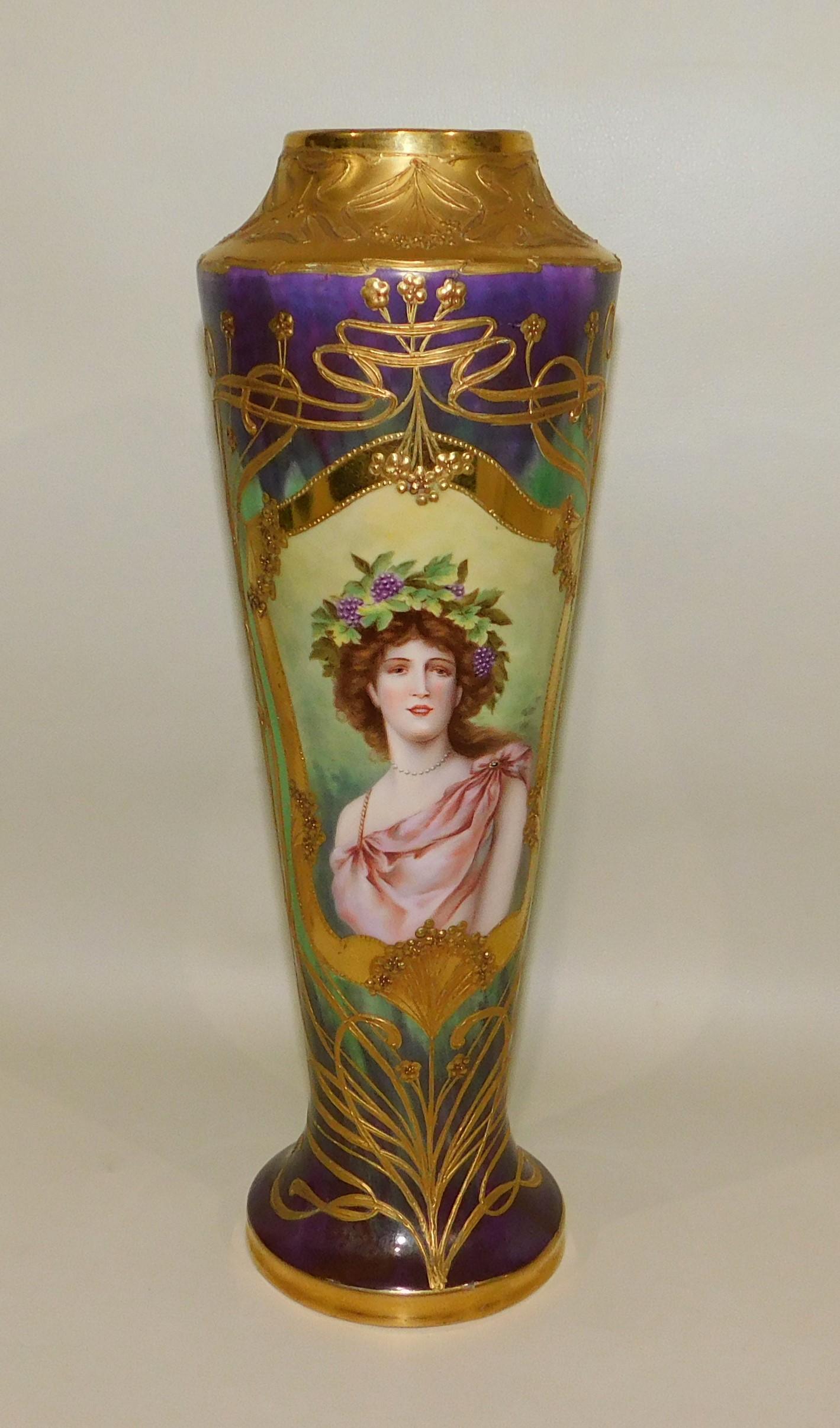 19th century Royal Vienna hand painted porcelain portrait drill vase. The body is covered with high quality gilt and raised gilt Art Nouveau style decoration. The center features an oval cartouche with a painting of a beautiful woman. The bottom has