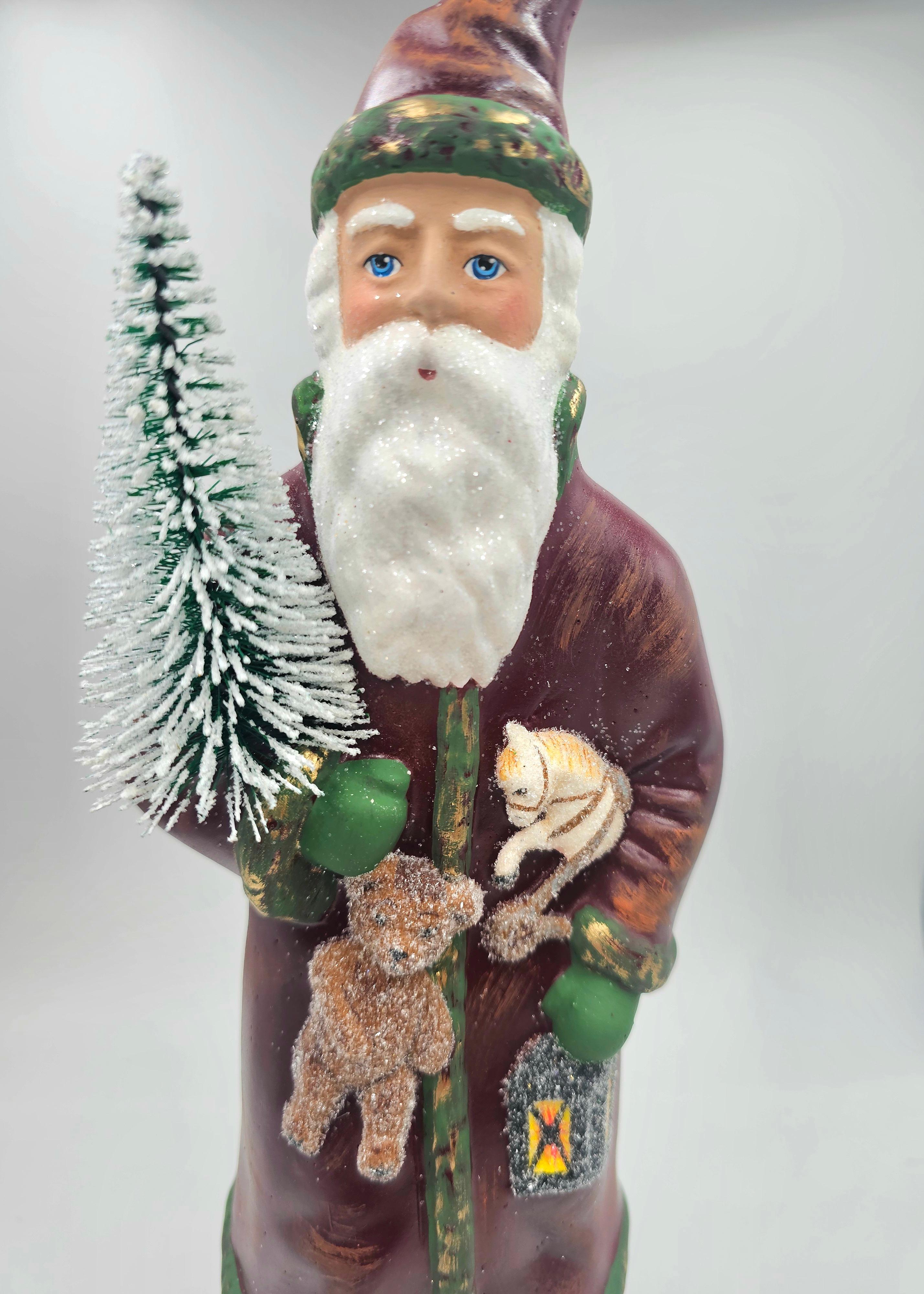 German Santa Claus figure made in papier-mâché in red and green colors with a hand painted detailed face. Holding a teddy bear and a tree. Hand-painted.
The Santa Claus is handmade from the original antique mold in Germany.
In the bottom stamped by