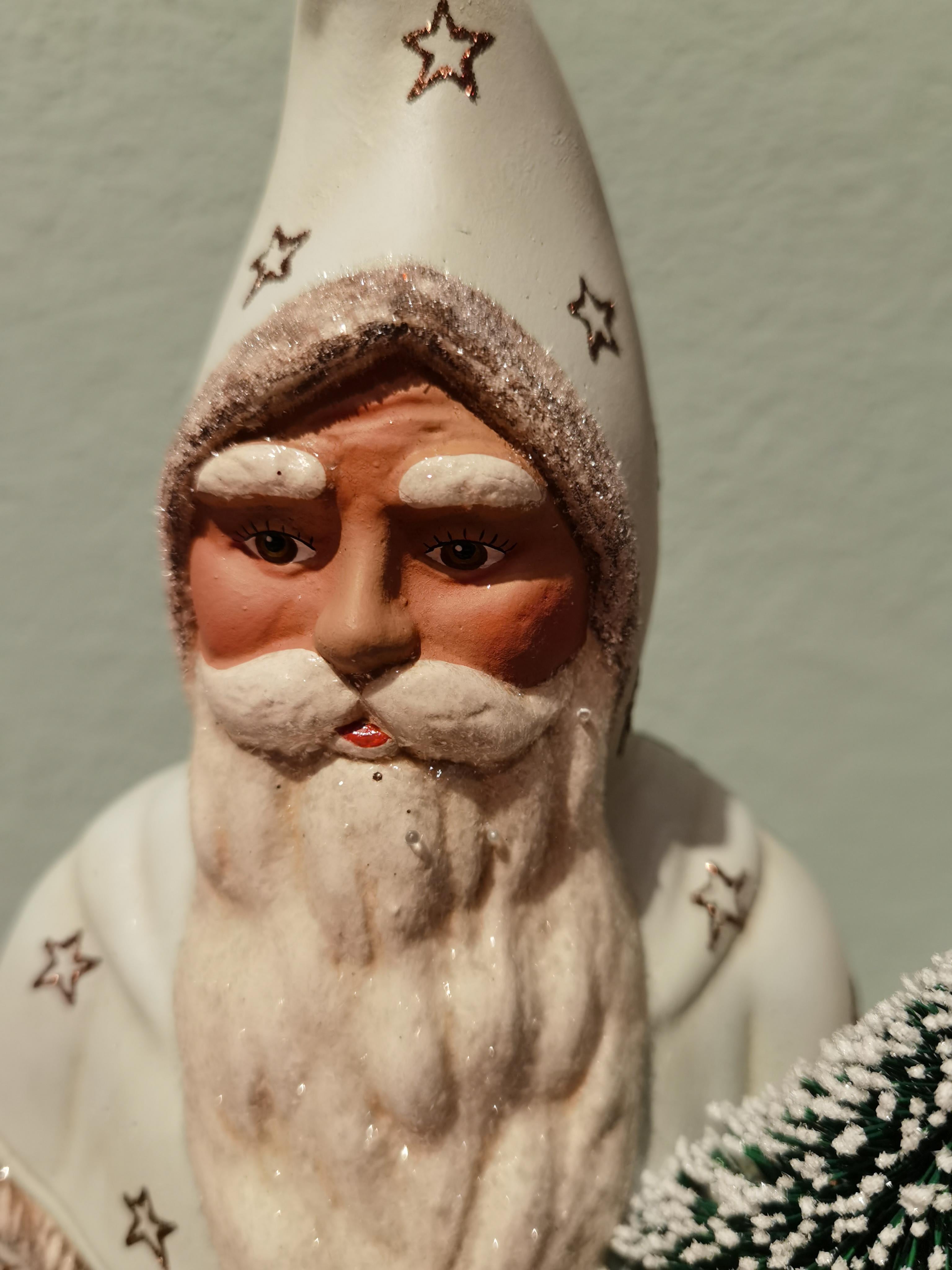 Large Santa Claus figure in hand painted pale blue papier mâché with a hand painted detailed face holding a tree. The Santa Claus is handmade in a original antique mould in Germany.