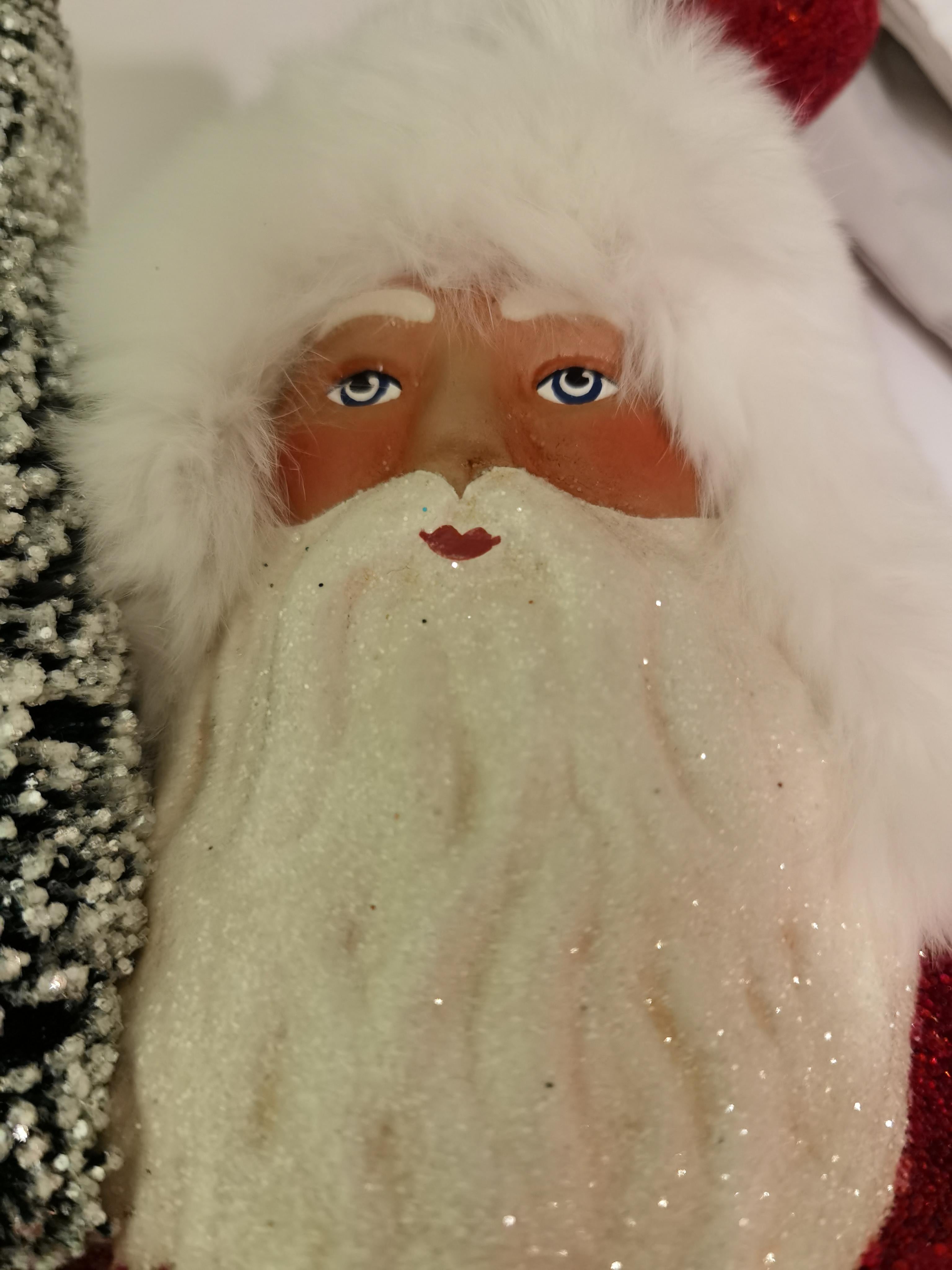 Large Santa Claus figure in papier mâché in red with a hand painted detailed face holding a tree. The Santa Claus is handmade in a original mould in Germany.