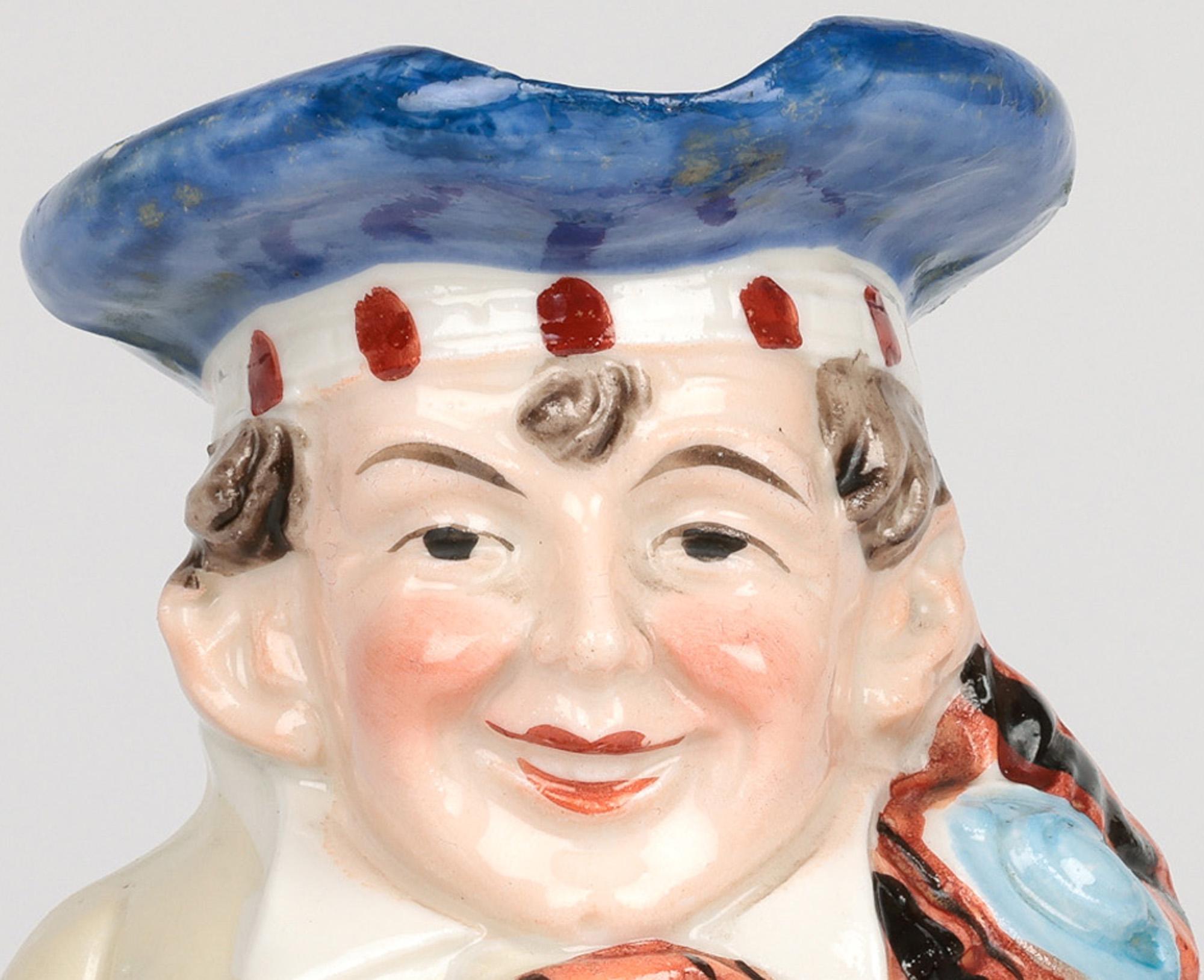 A delightful and unusual antique German porcelain figural Scotsman character jug attributed to Schafer & Vater dating from around 1900. This charming and quality jug stands on a flat round unglazed base with a barrel shaped body formed in relied as